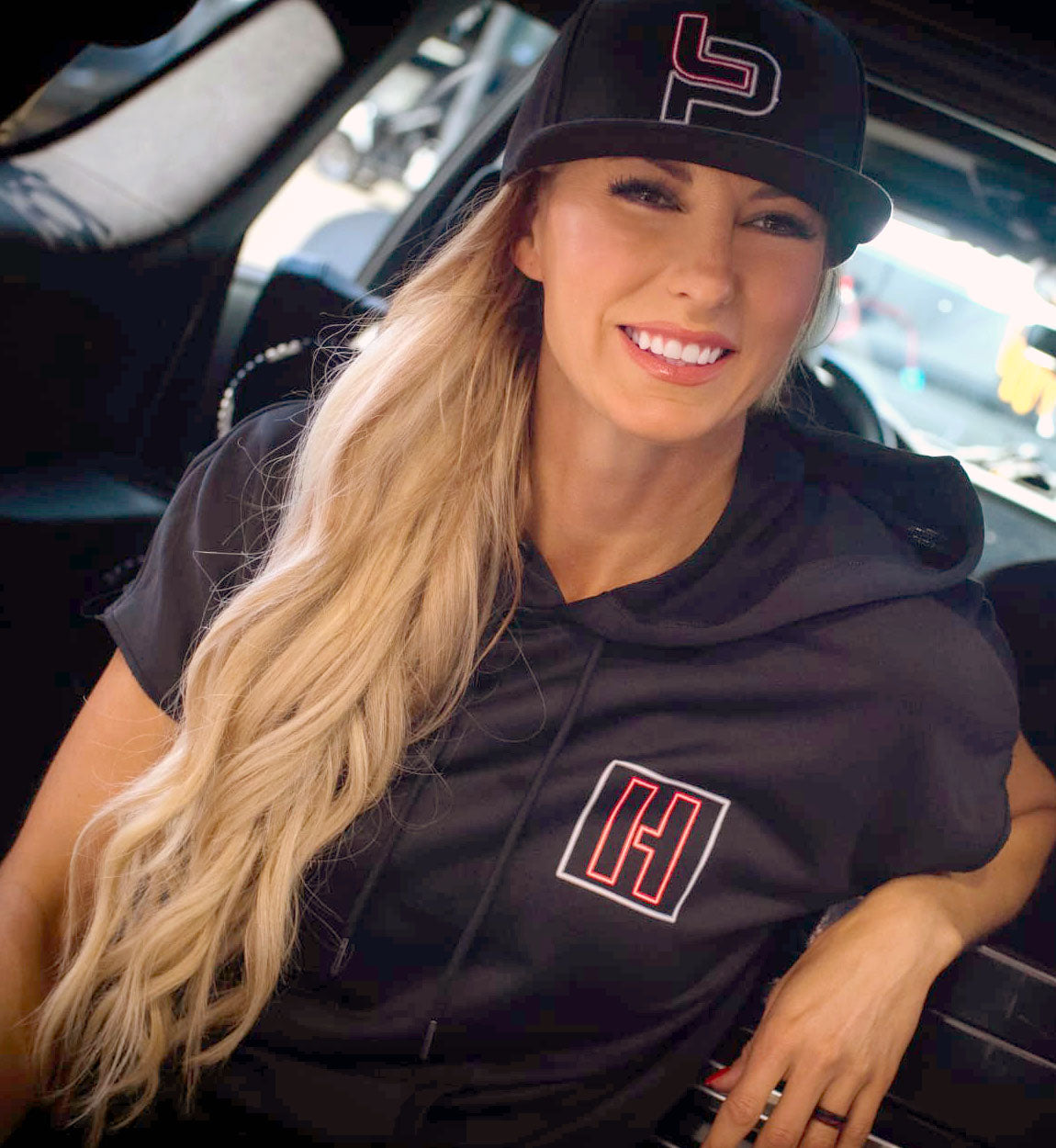 Black short sleeve pullover hoodie for women featuring Hoonigan and Leah Pruett LP ENERGY branding, perfect for casual wear.