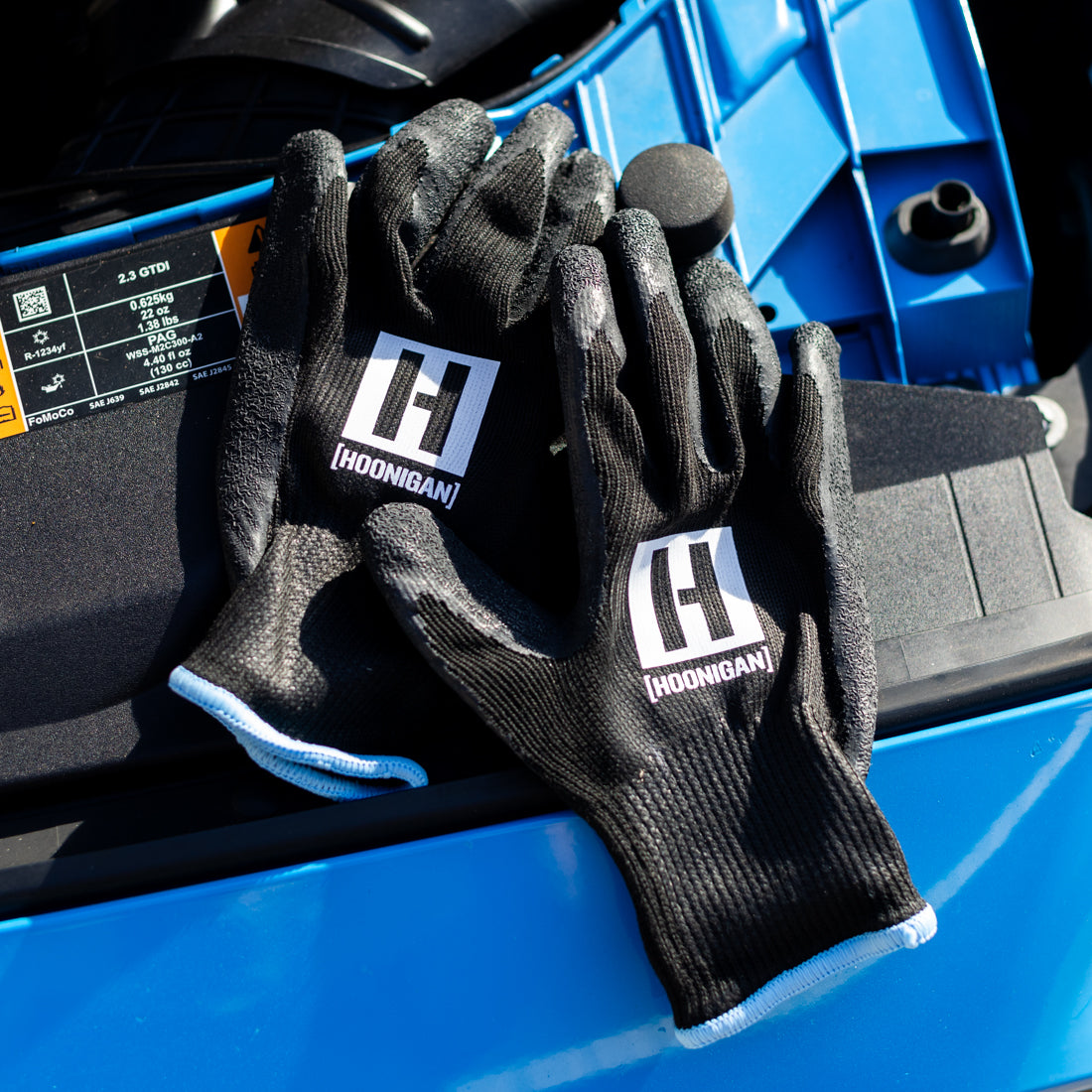 Hoonigan HBOX work gloves featuring a rugged design with reinforced palms, adjustable wrist straps, and a breathable material for enhanced grip and comfort.