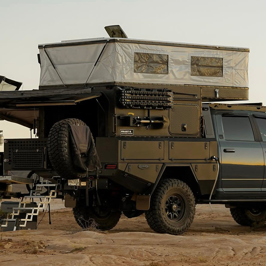 Hoonigan CENSOR BAR Spare Tire Tailgate Backpack attached to an off-road vehicle, showcasing rugged design for outdoor adventures.