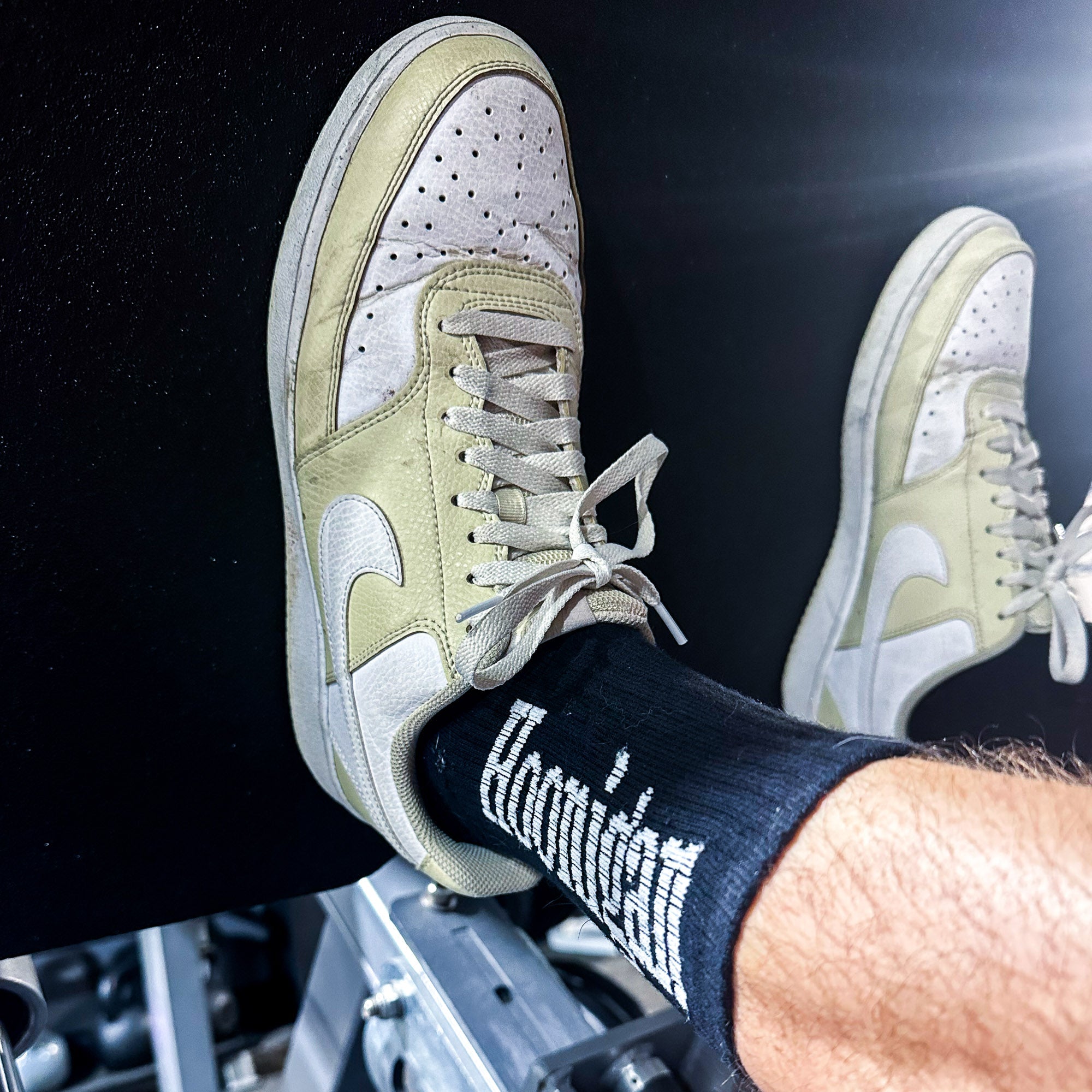 Hoonigan BURNOUT TEAM socks featuring a bold logo, paired with stylish sneakers during a workout session.