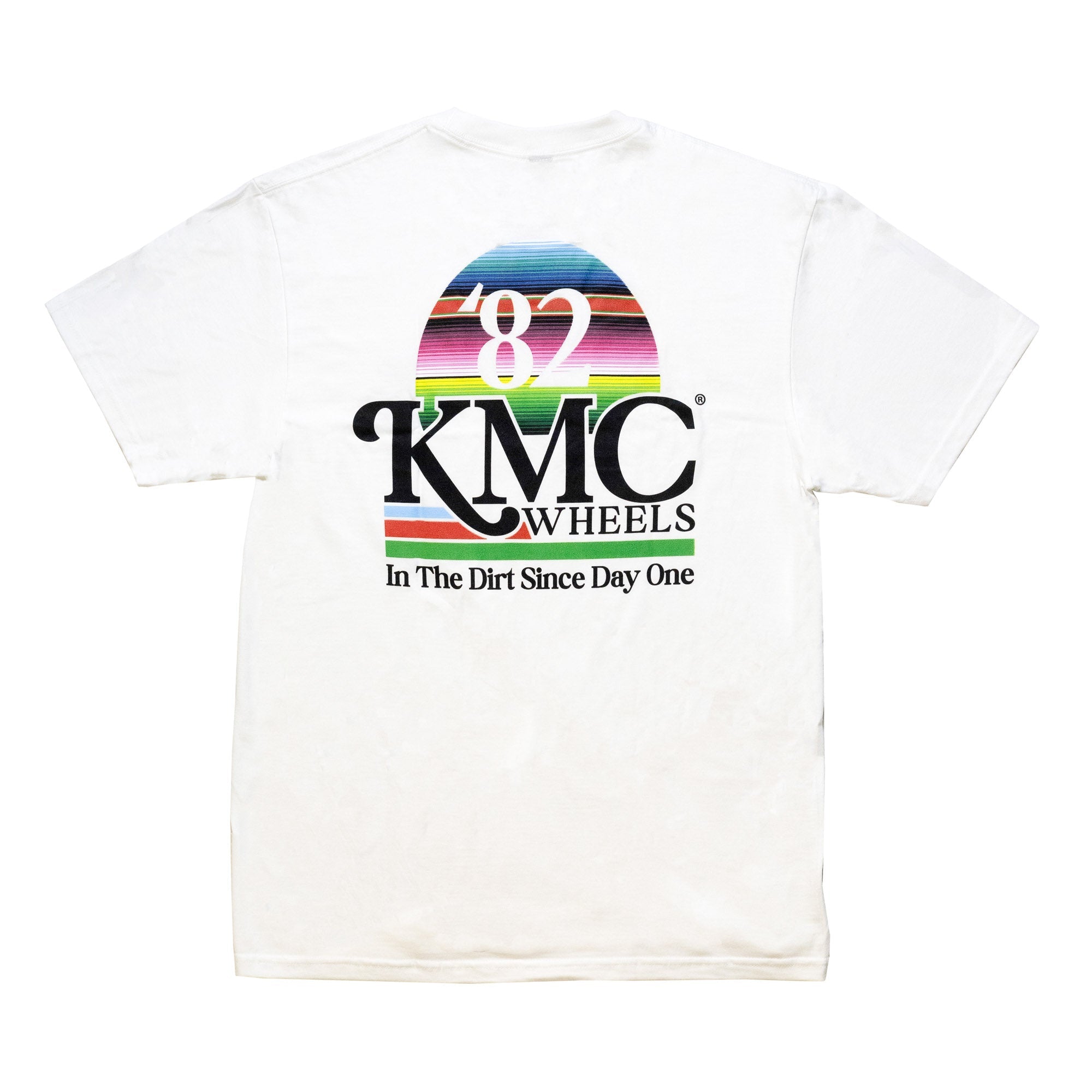 White KMC DAY ONE short sleeve tee featuring a colorful graphic design with "82" and "KMC Wheels" logo, and "In The Dirt Since Day One" text.