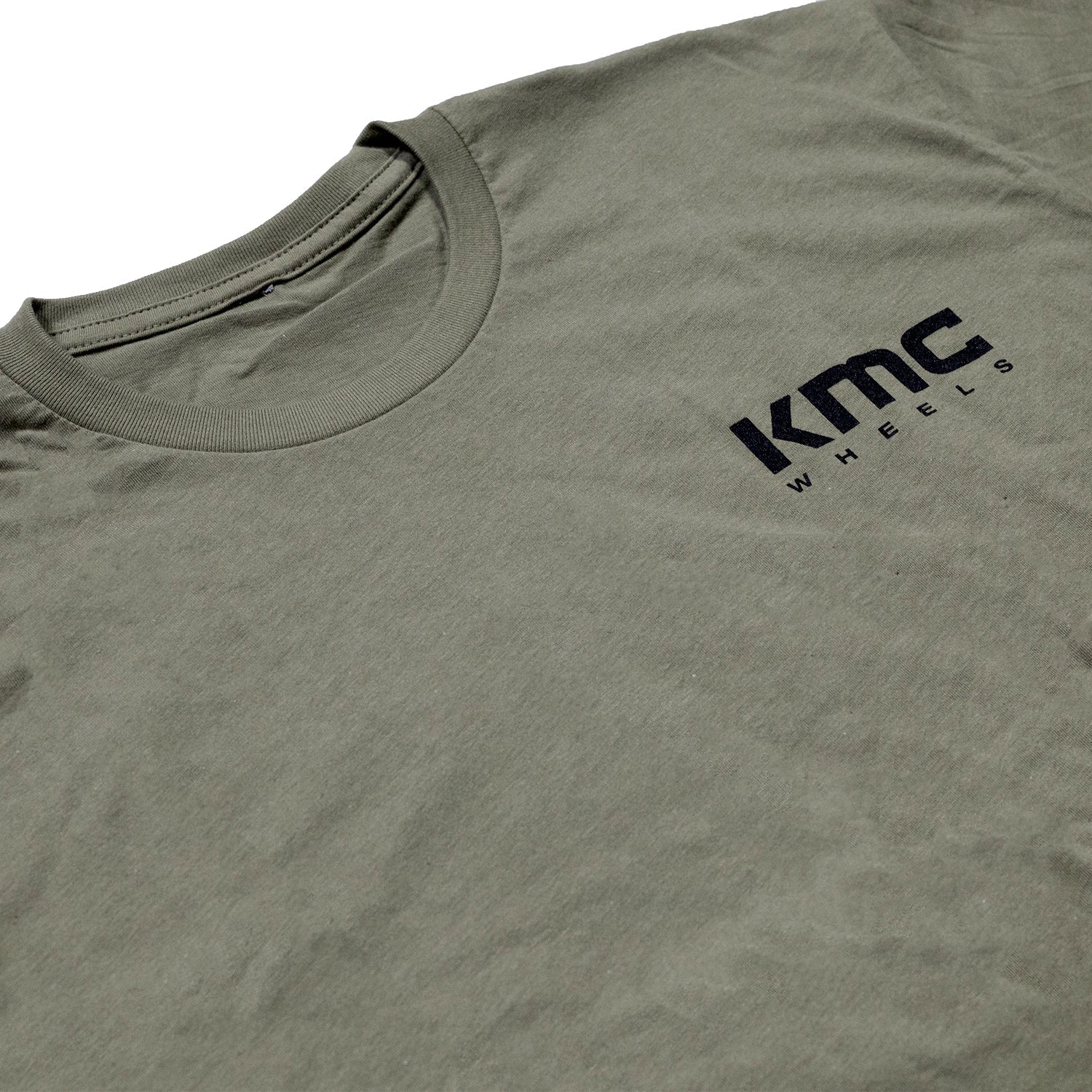 KMC logo short sleeve tee in navy blue with white branding, displayed on a flat surface.