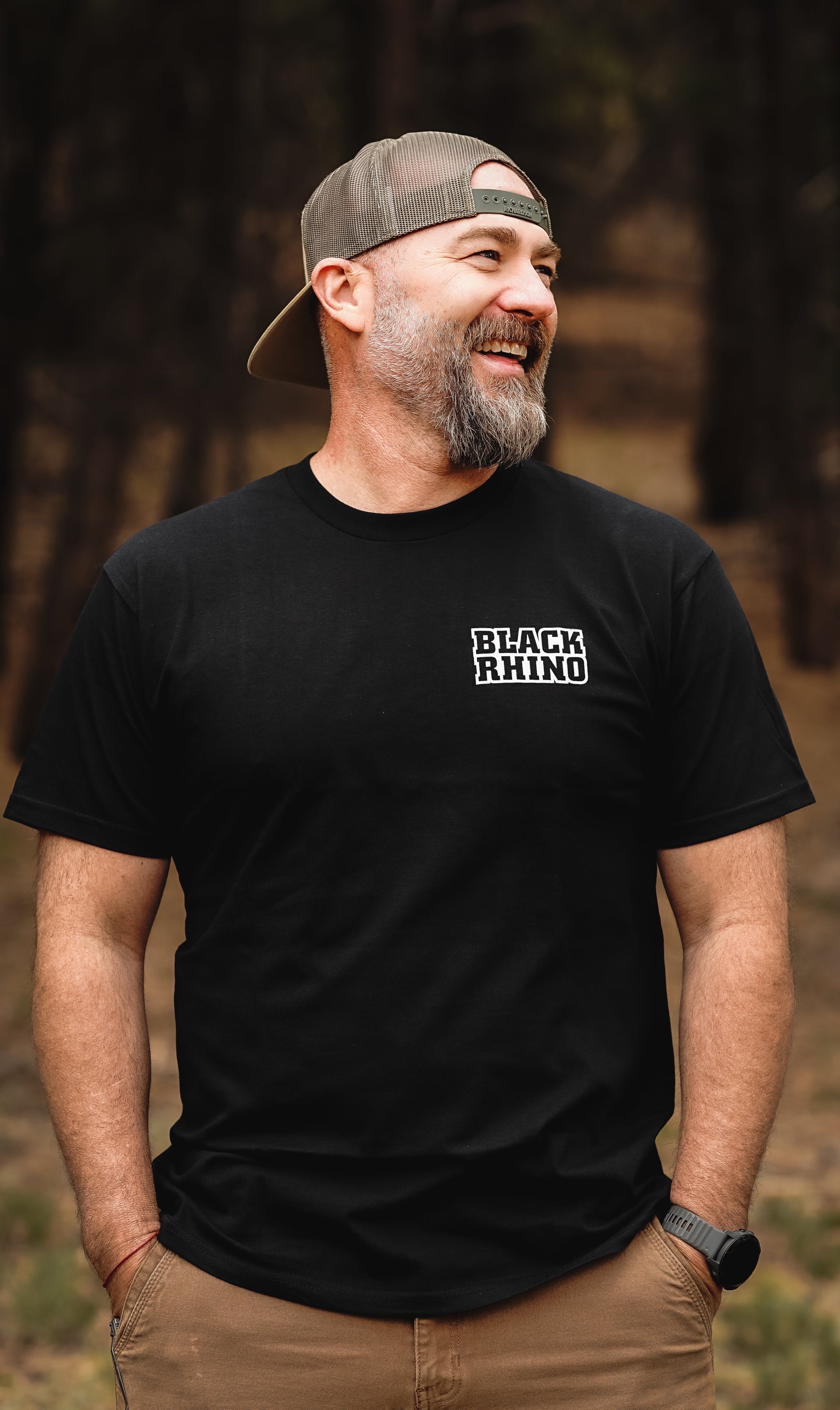 Black Rhino FLYER Short Sleeve Tee in dark color, featuring the logo prominently displayed on the front, set against a minimal background.
