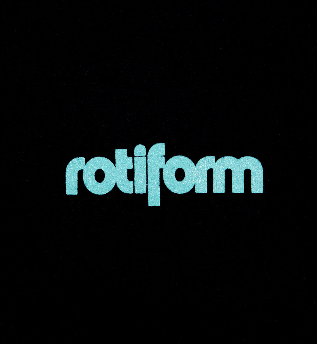 Rotiform STAPLE Short Sleeve Tee in black with teal logo detail on the front.