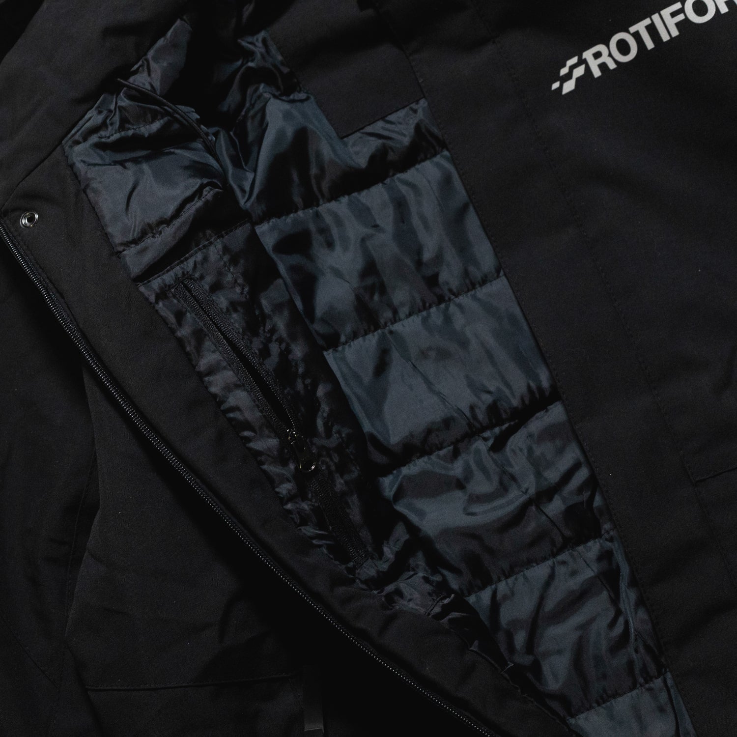 Rotiform MOTOSPORTS DIV Reflective Jacket featuring a sleek design with reflective accents, perfect for visibility and style during outdoor activities.