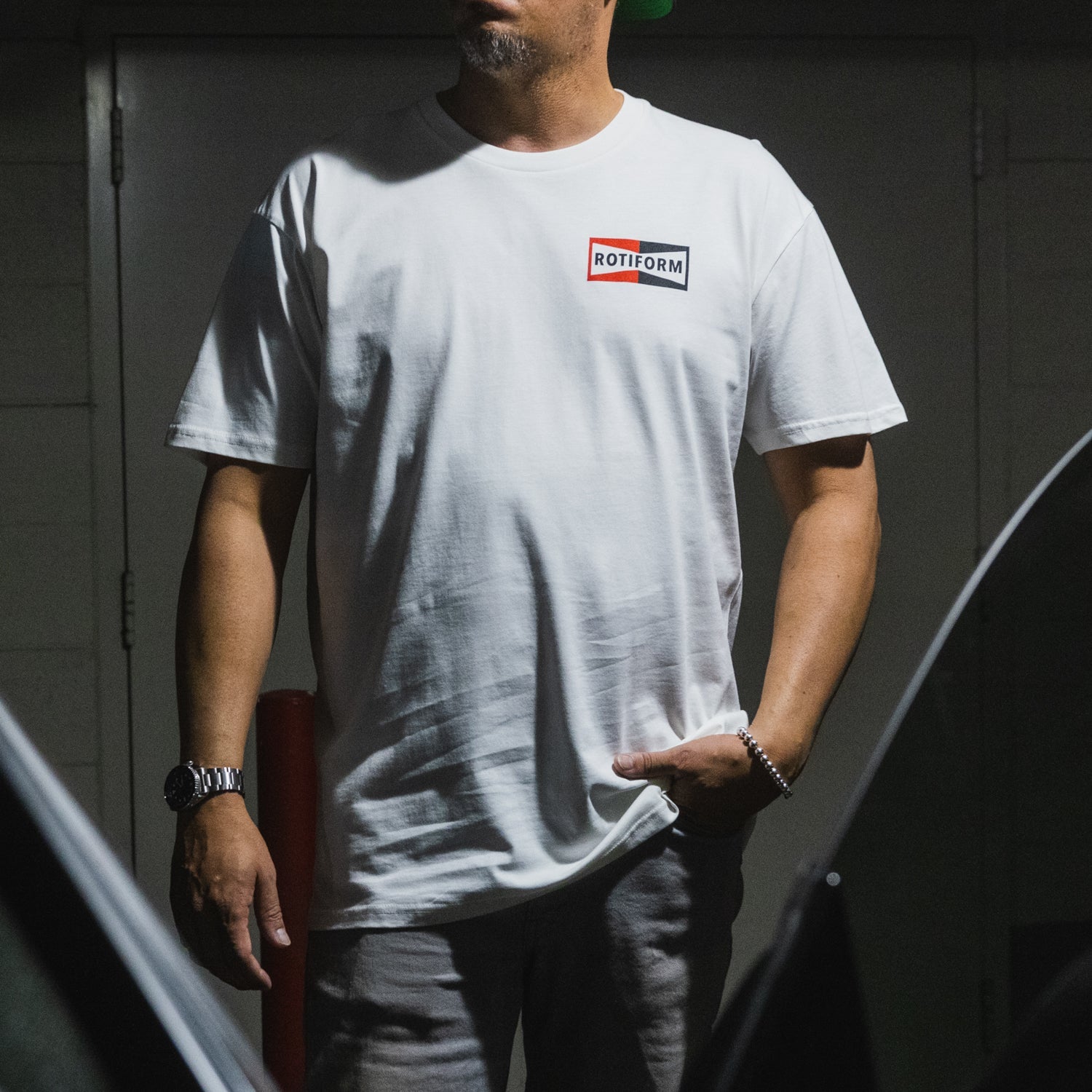 Rotiform NEED THAT PLUG short sleeve t-shirt featuring a bold graphic on the front, in black color, perfect for casual wear.