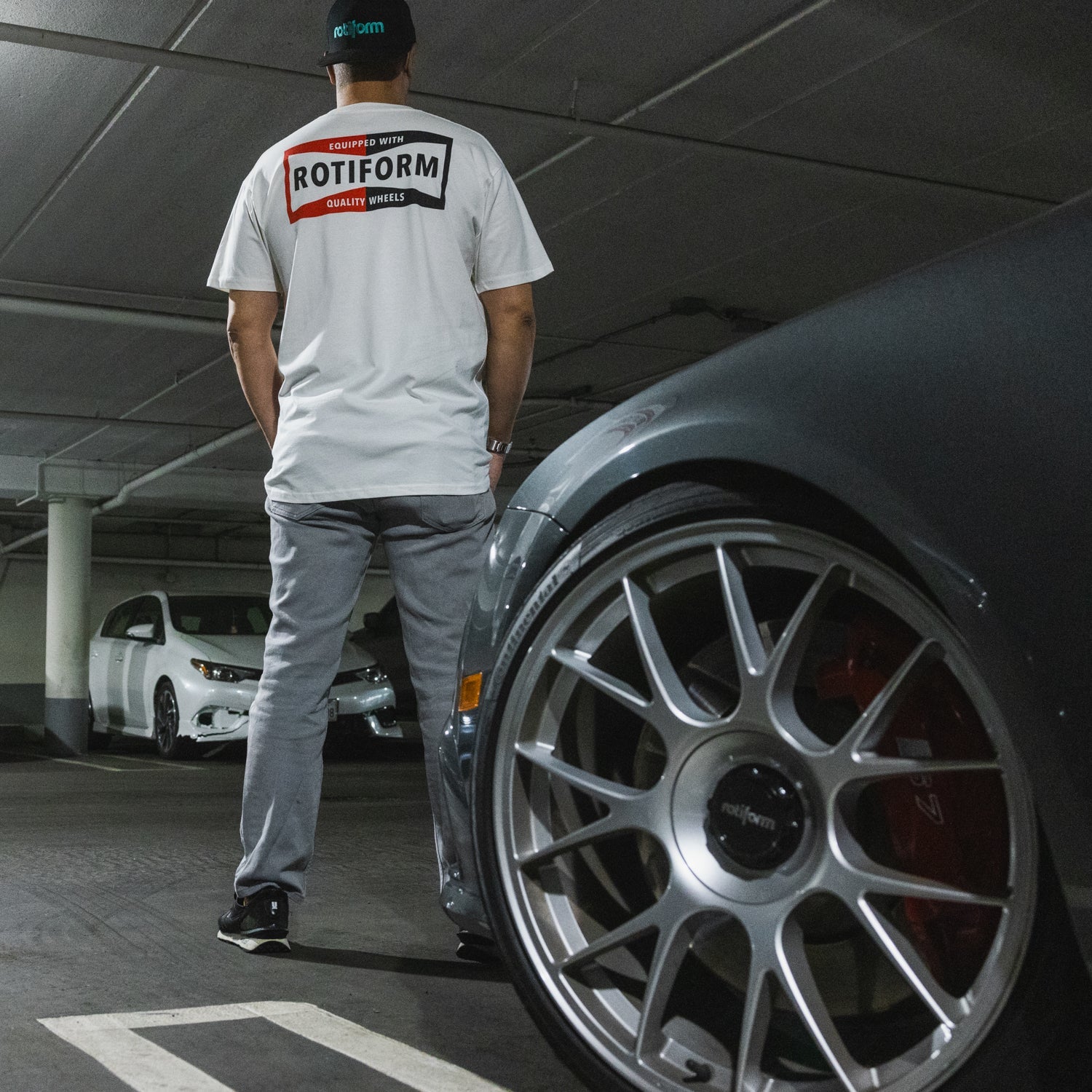 Rotiform NEED THAT PLUG short sleeve tee in black, featuring a bold white graphic design on the front.