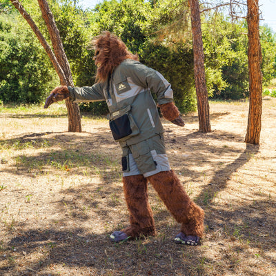 A person in a rain-activated Hoonigan H.A.V.O.C. windbreaker jacket, standing outdoors among trees on a sunny day.