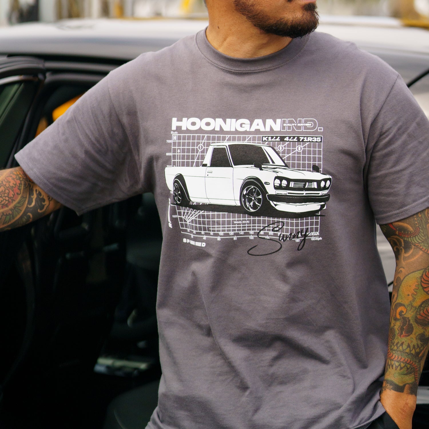 Hoonigan SUNS OUT Short Sleeve Tee in black featuring a vibrant graphic design on the front.