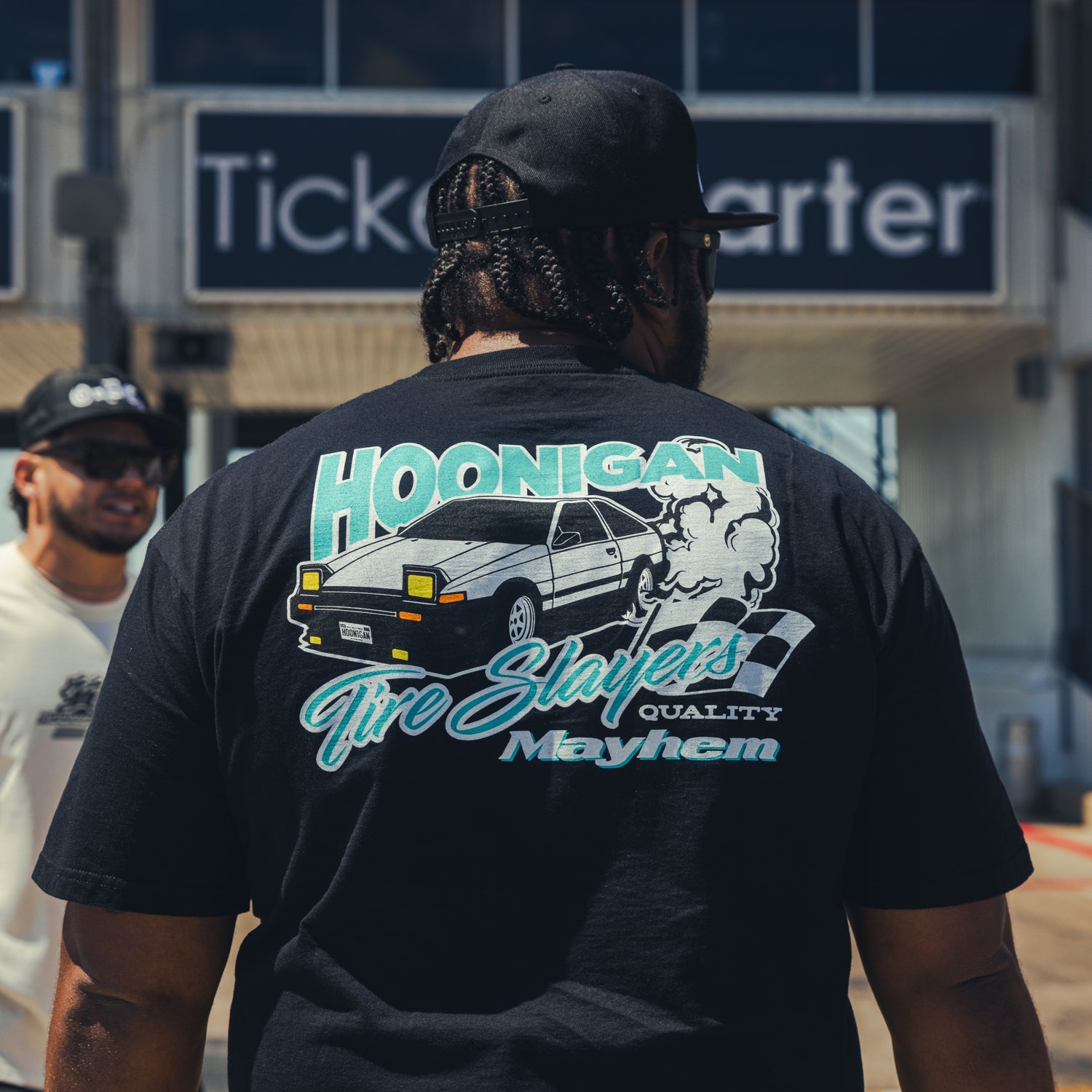 Hoonigan 86 TIRE SLAYERS Short Sleeve Tee featuring bold graphic design on a black background.