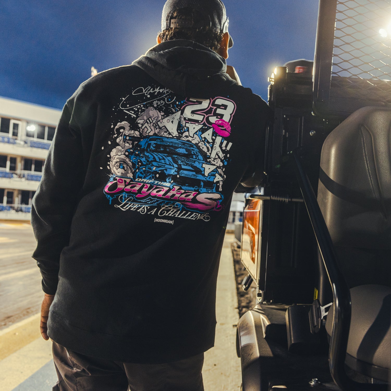 Hoonigan x Sayaka Drift Pullover Hoodie featuring a graphic design of Sayaka in vibrant colors on a black background.