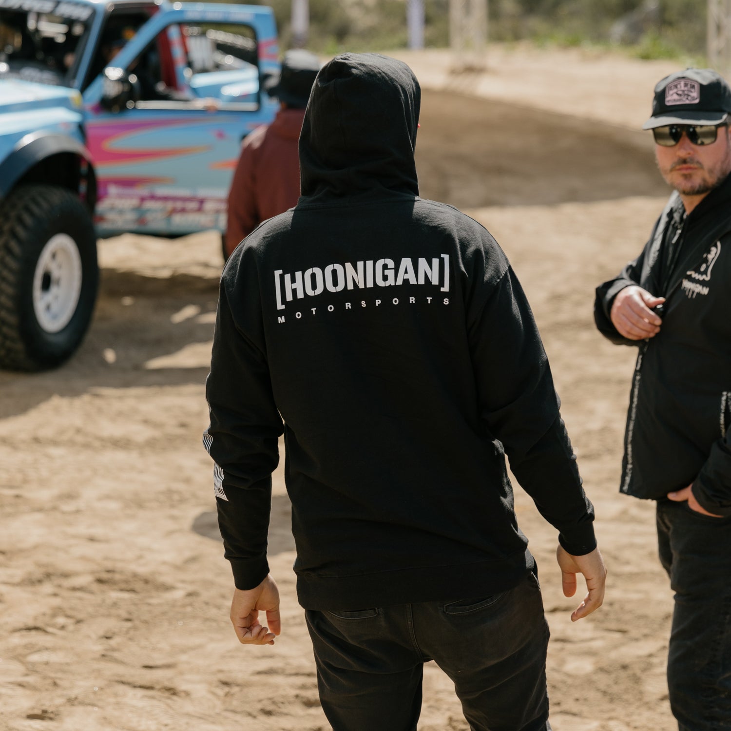 Black Hoonigan Motorsports pullover hoodie featuring a bold logo on the chest and a drawstring hood, ideal for motorsport enthusiasts.