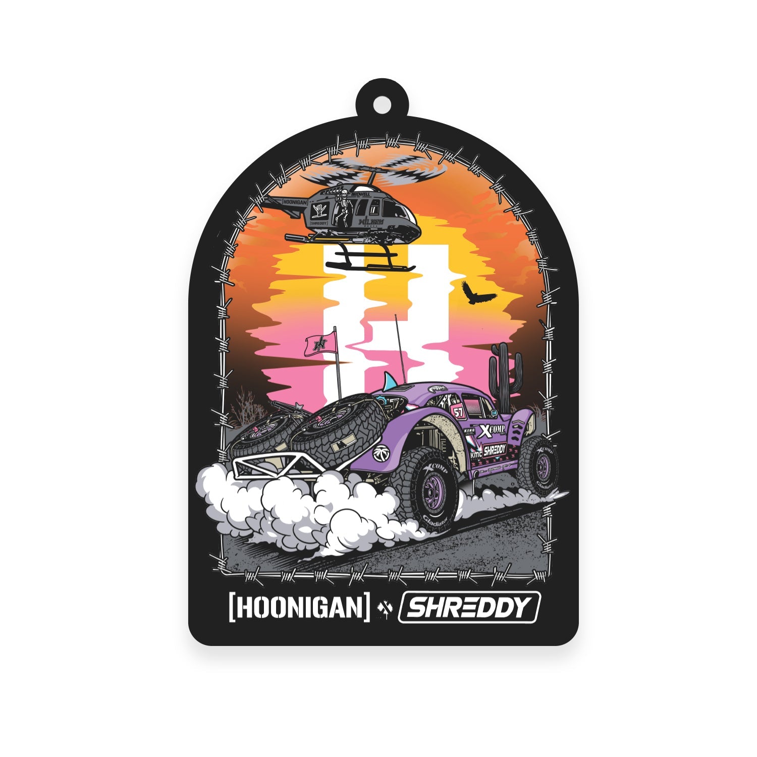 Hoonigan x Shreddy DESERT Air Freshener featuring a vibrant off-road vehicle and helicopter against a sunset backdrop.