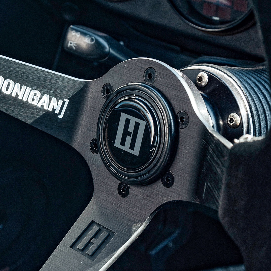Hoonigan H BOX HORN button featuring a sleek design and the iconic Hoonigan logo, ideal for enhancing racing steering wheels.