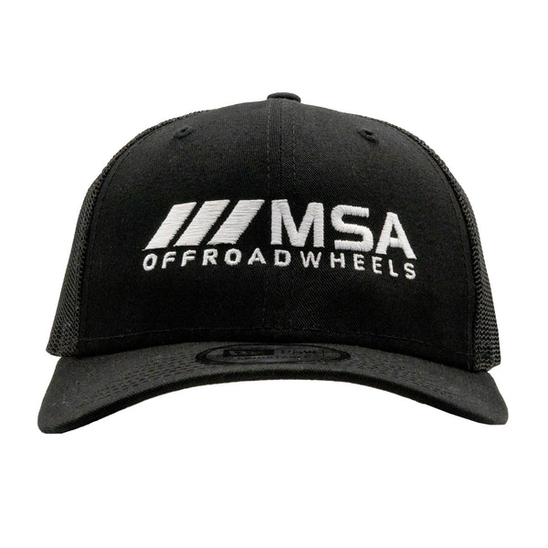 Black trucker hat featuring the MSA Wheels logo in white embroidery, perfect for off-road enthusiasts and motorsport fans.