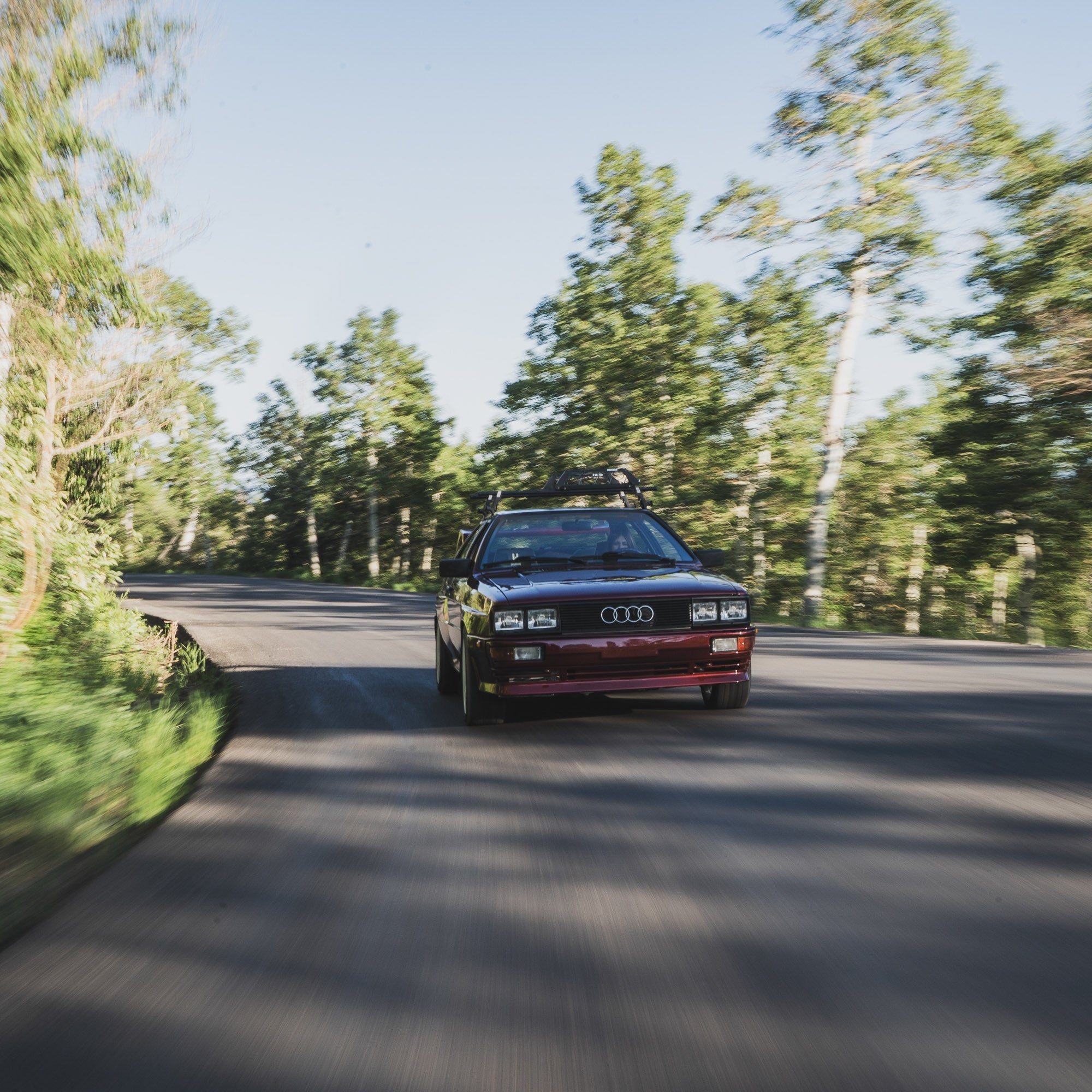 Hoonigan x Lia Block UR VINTAGE Pullover Hoodie displayed with a classic Audi driving on a winding road surrounded by trees.