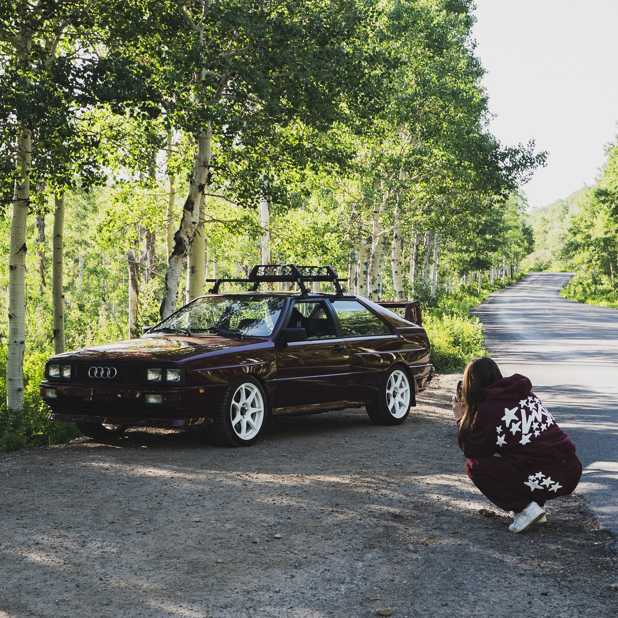 Hoonigan x Lia Block CENSOR BAR Sticker displayed on a car in a scenic forest setting, showcasing automotive culture.