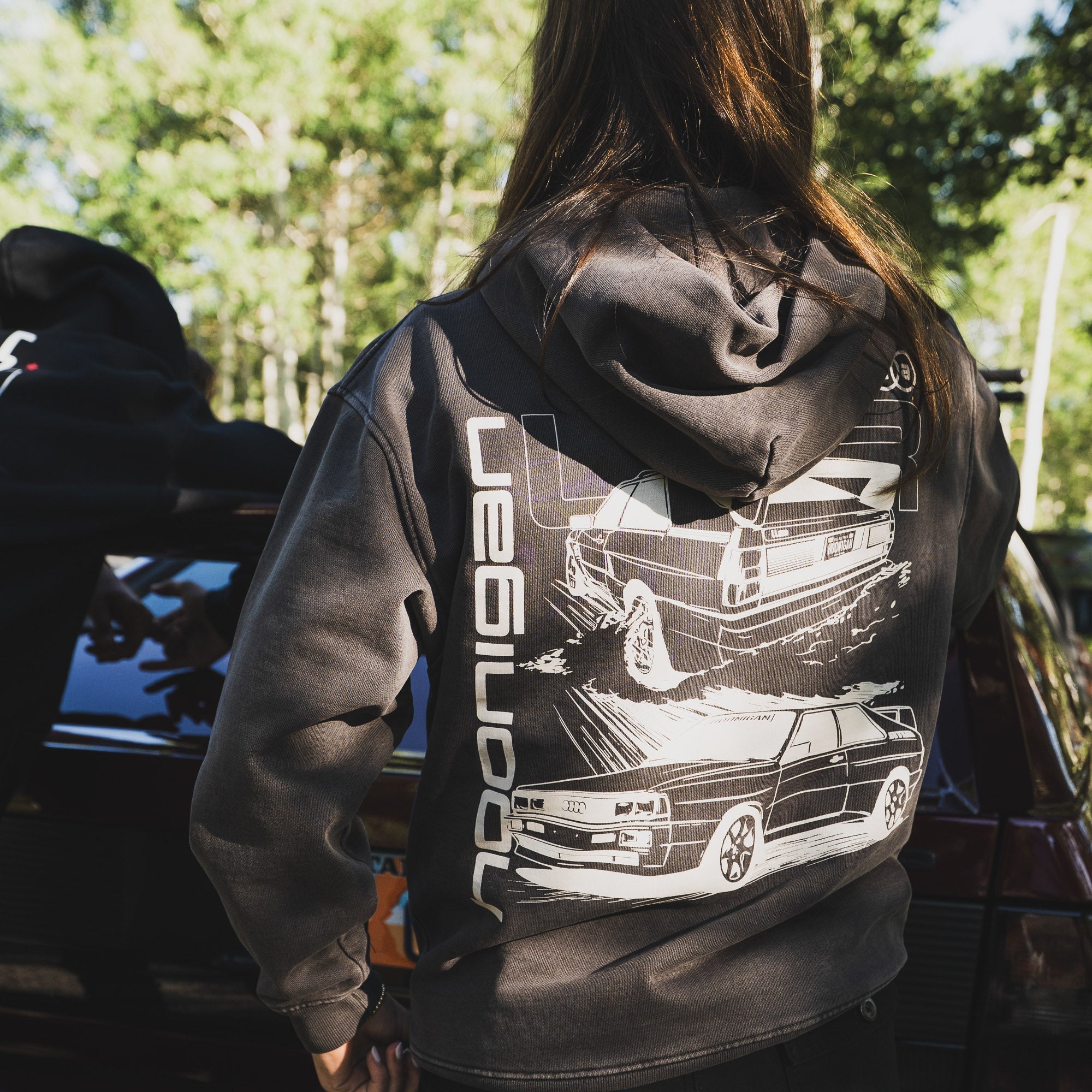 Hoonigan x Lia Block UR VINTAGE Pullover Hoodie featuring a retro car graphic on the back, worn outdoors.