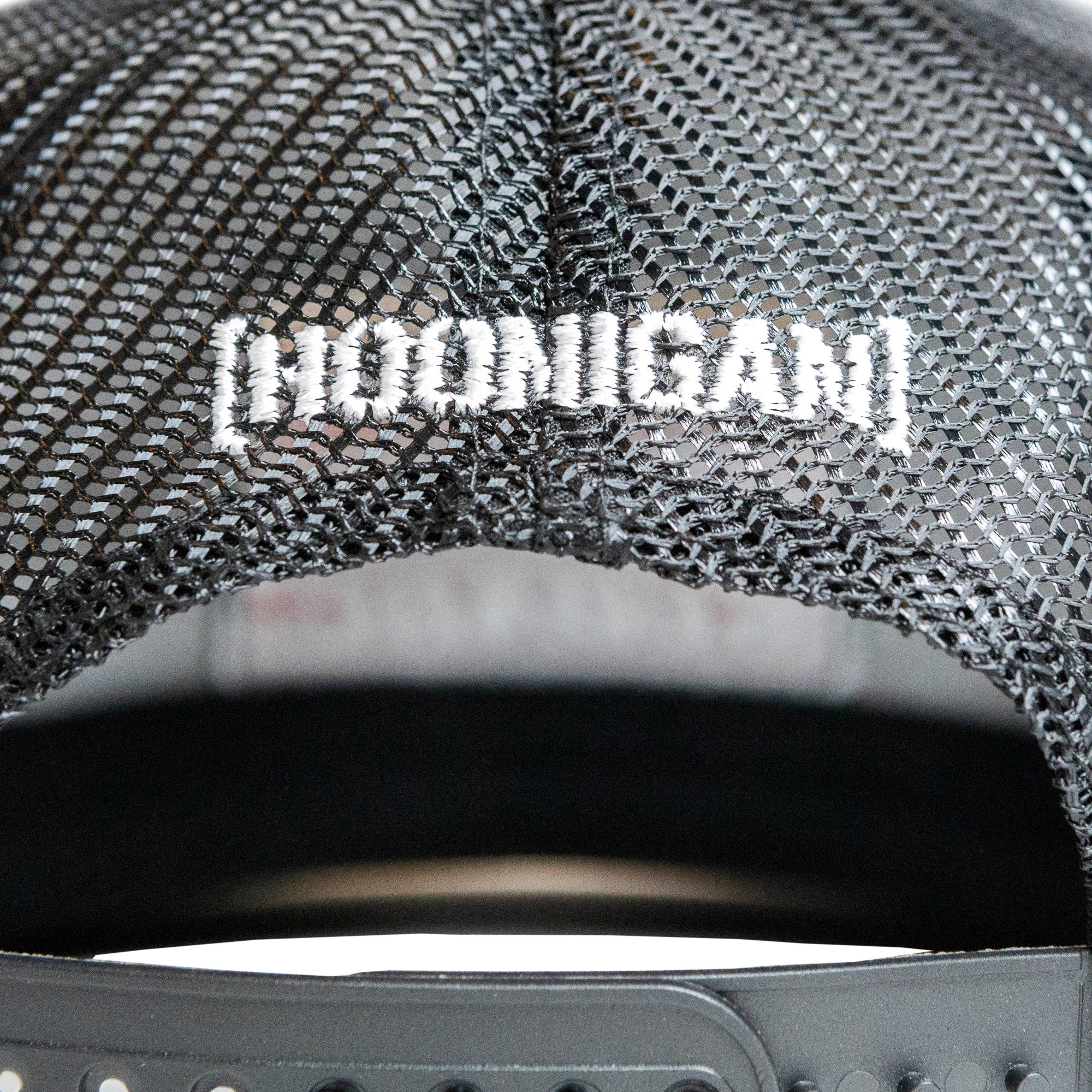 Black mesh trucker snapback hat featuring Hoonigan logo embroidered on the back, designed for motorsport enthusiasts.