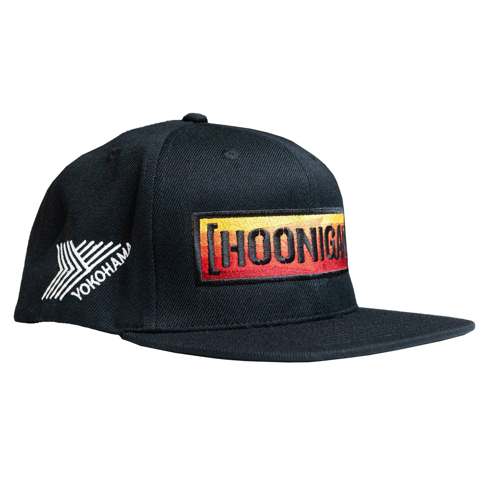 Black snapback hat featuring a bold embroidered Hoonigan logo in red and yellow, with a Yokohama logo on the side.