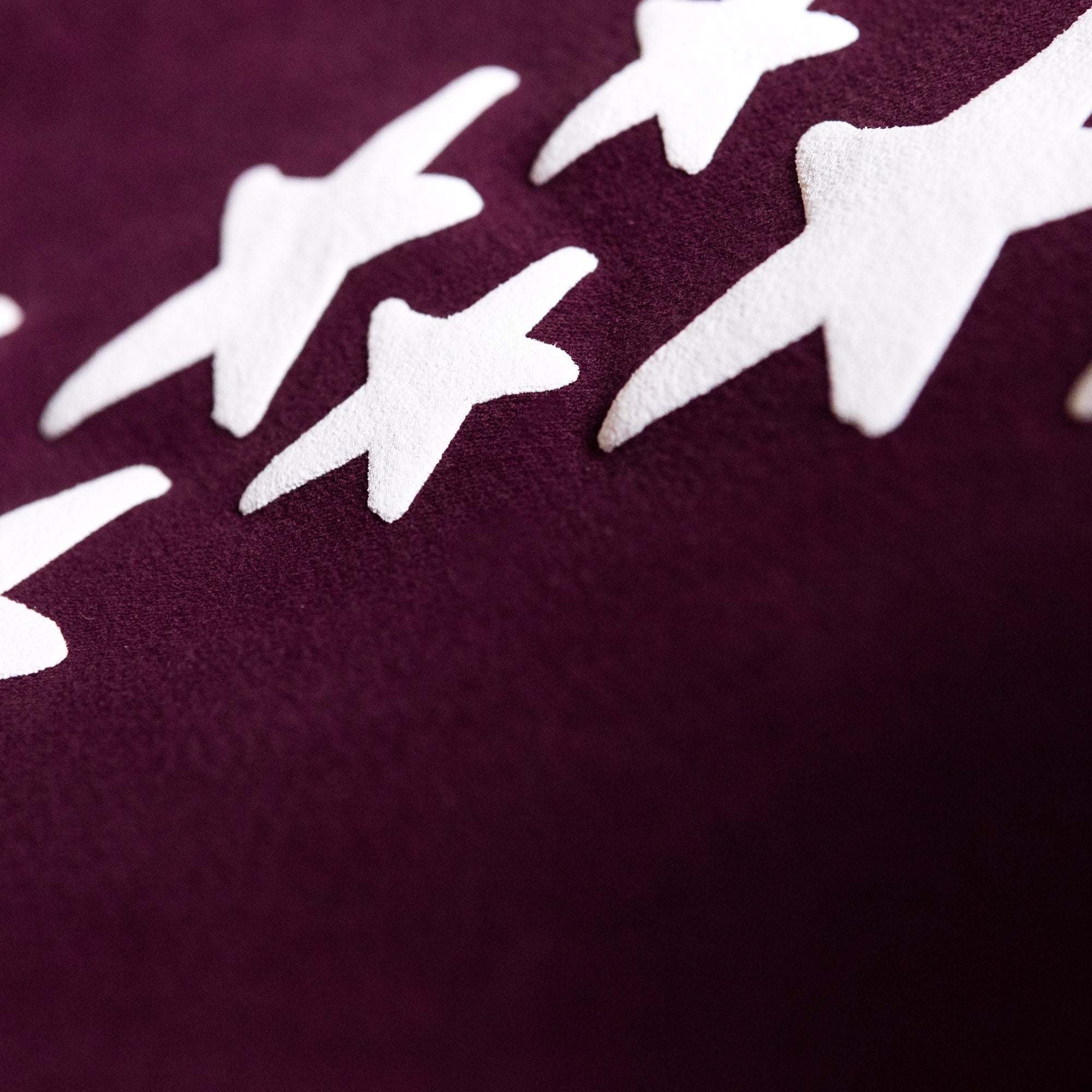 Close-up of Hoonigan x Lia Block UR STAR Sweatpants featuring a bold star graphic on a rich burgundy fabric.