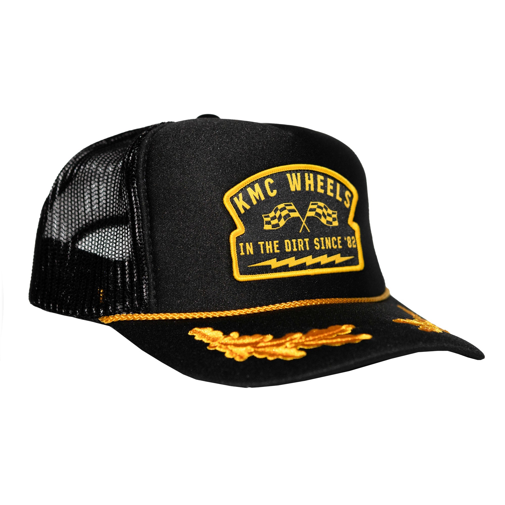 KMC IN THE DIRT CAPTAIN Trucker Hat featuring a black design with yellow logo and embroidered details for motorsport enthusiasts.
