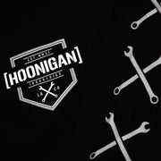 Black long sleeve t-shirt featuring Hoonigan logo and crossed wrench graphics, perfect for motorsport enthusiasts.