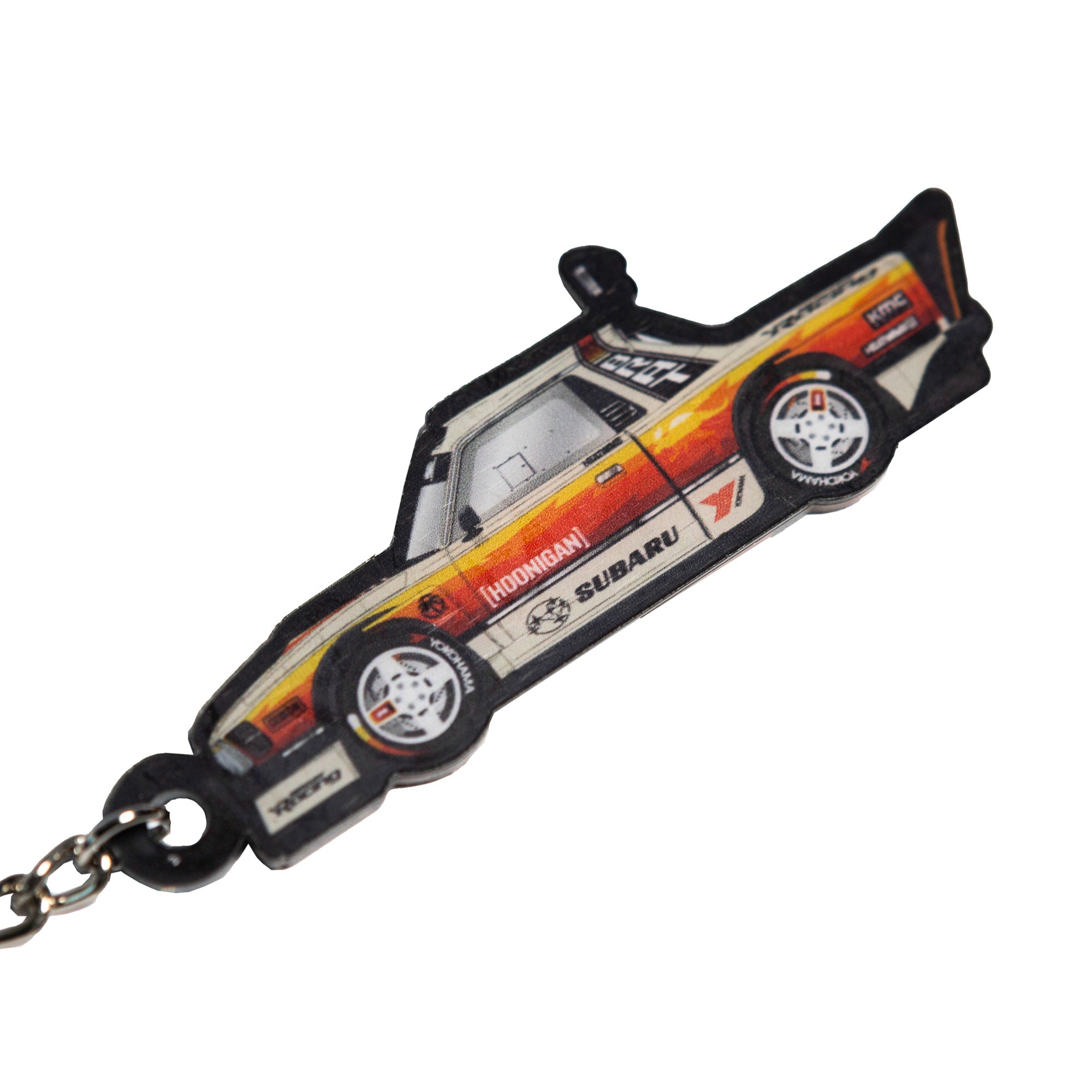 Hoonigan GYMKHANA AUSSIE SHRED LIVERY keychain featuring a detailed design of a classic Subaru car.