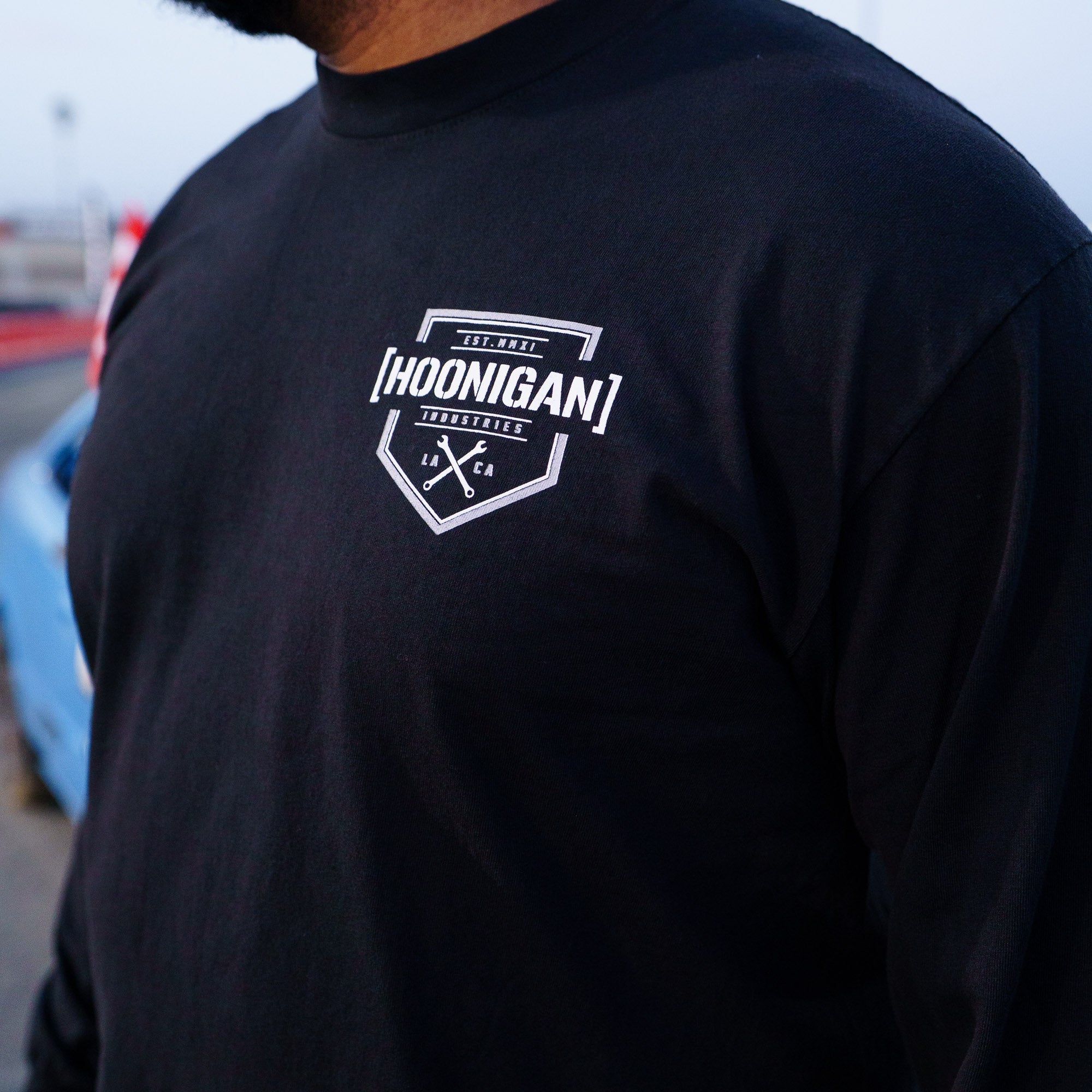 Hoonigan Bracket X Logo long sleeve t-shirt featuring a bold logo on a black fabric, perfect for motorsport enthusiasts.