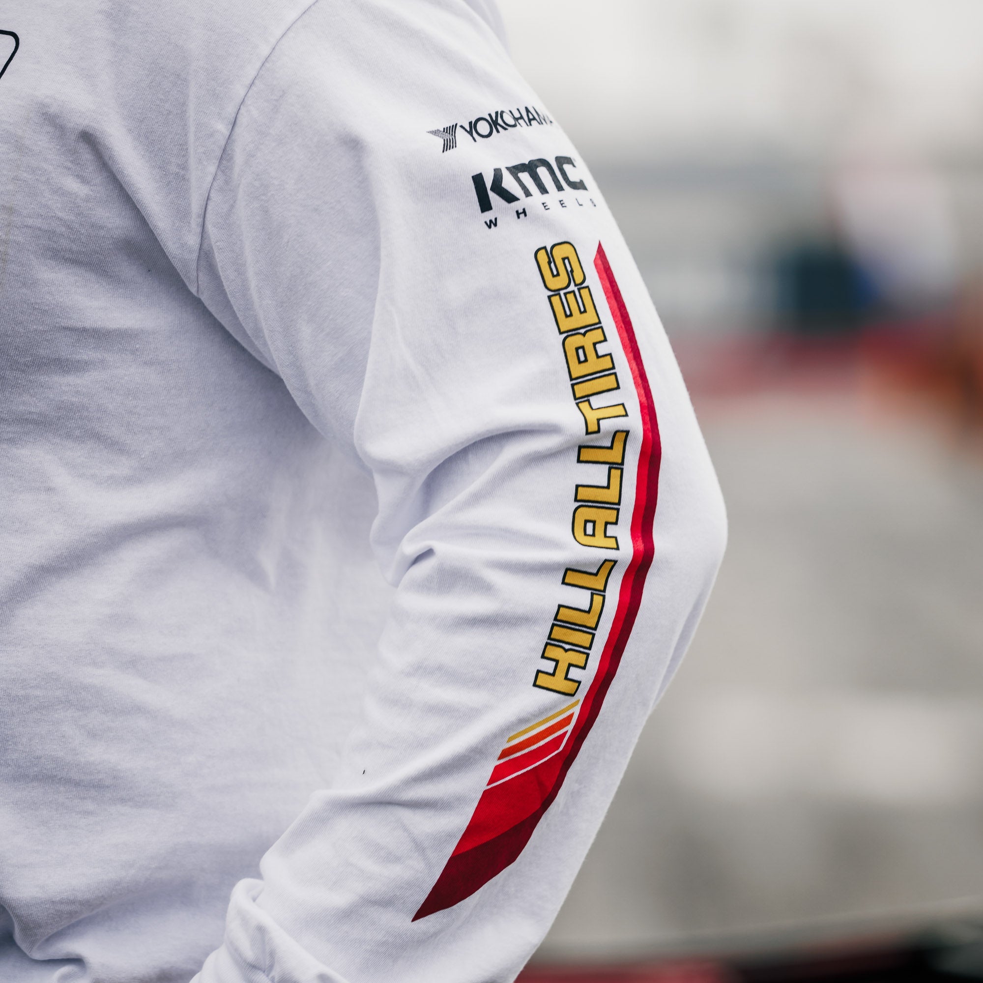 Long sleeve white t-shirt featuring Hoonigan branding and sponsor logos, perfect for motorsport enthusiasts.