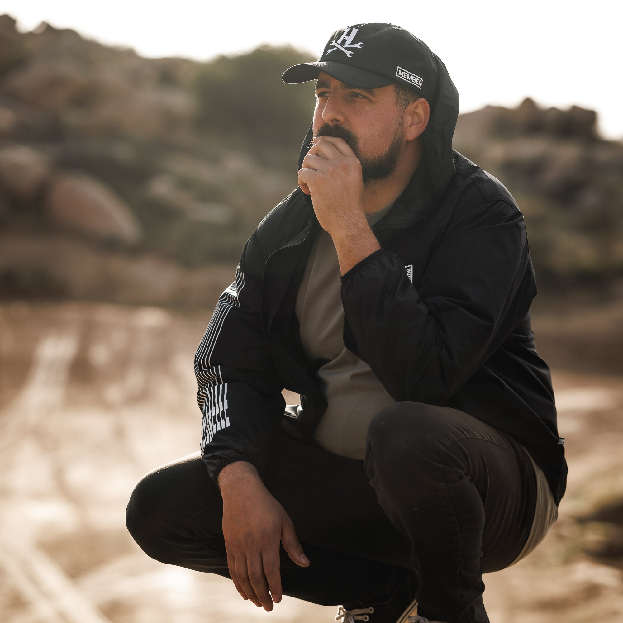 Hoonigan Motorsports pullover hoodie featuring a black design with bold logo graphics on the front and sleeves.