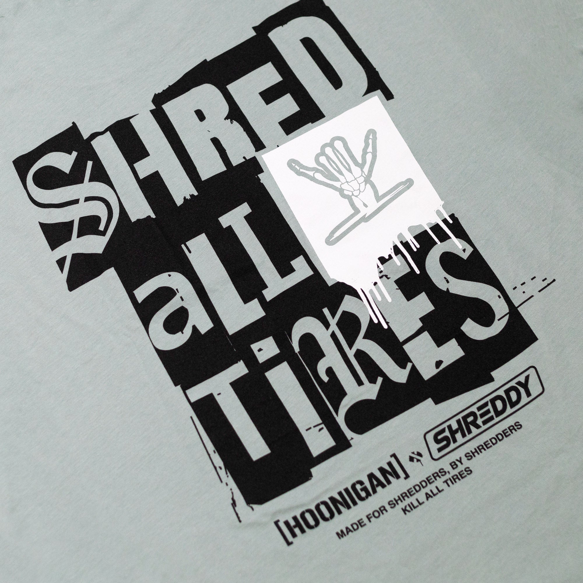 Hoonigan x Shreddy SHRED ALL TIRES short sleeve t-shirt featuring bold graphic print and unique design for car enthusiasts.