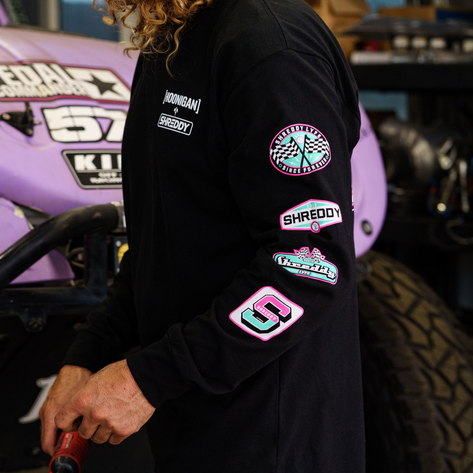 Hoonigan x Shreddy 57 long sleeve t-shirt featuring vibrant logos on the sleeves, perfect for motorsport enthusiasts.