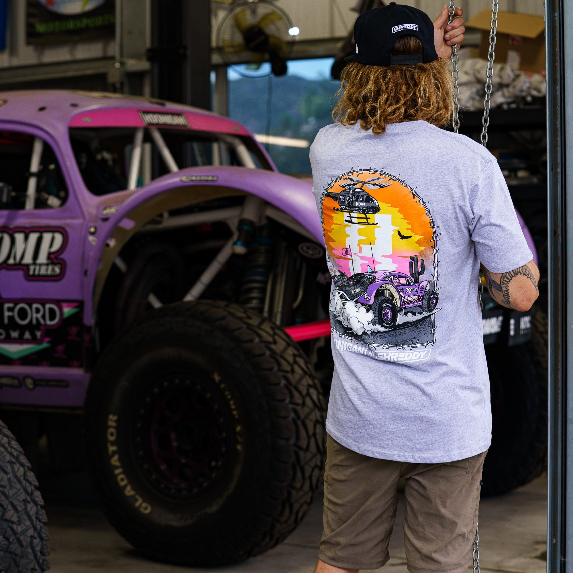 Short sleeve Hoonigan x Shreddy Desert Shred T-shirt featuring a vibrant graphic of a desert scene and off-road vehicle.