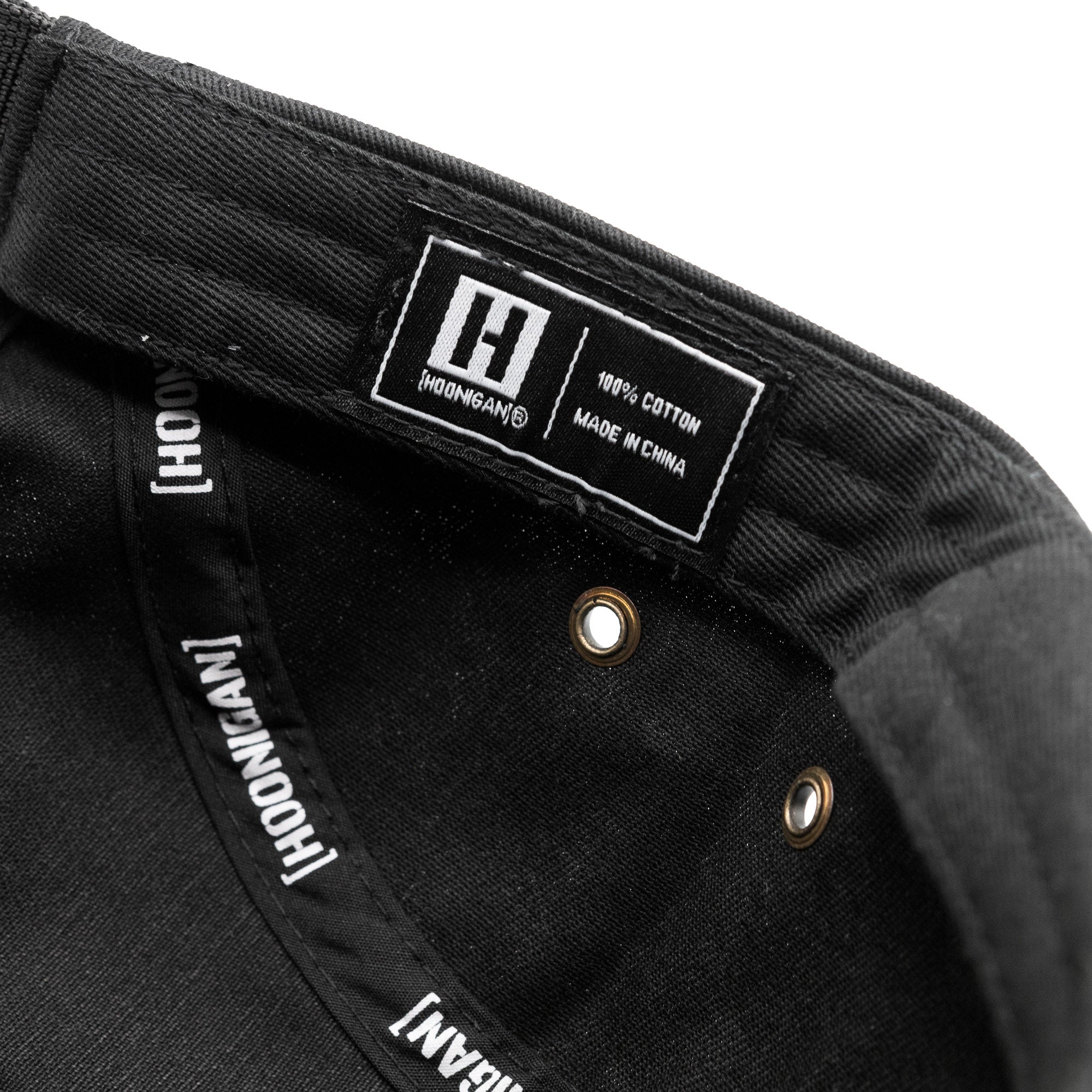 Inside view of Hoonigan CENSOR BAR unstructured strapback hat showing brand label and cotton material details.