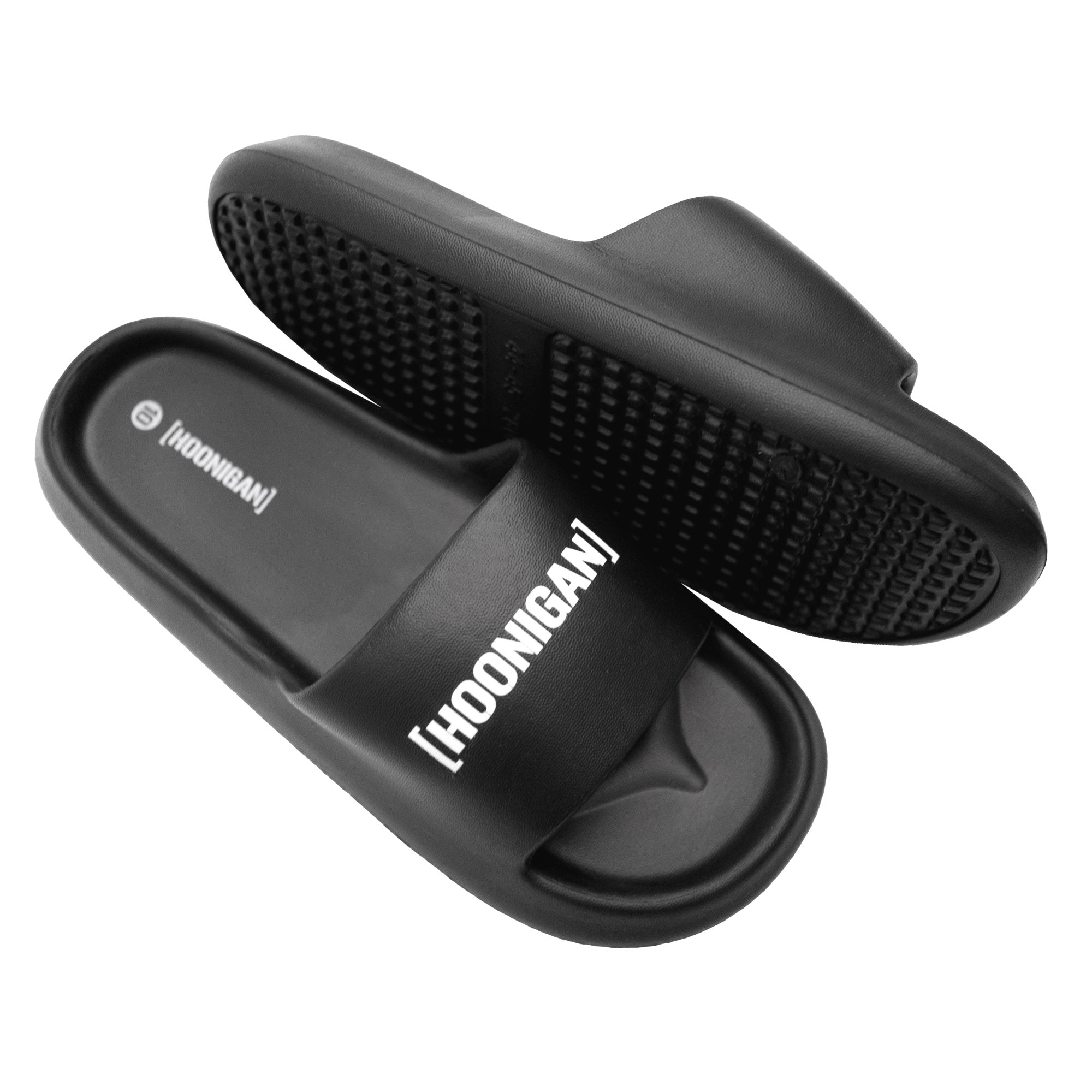 Black Hoonigan slides featuring a bold logo on the strap and a textured sole for grip and comfort.