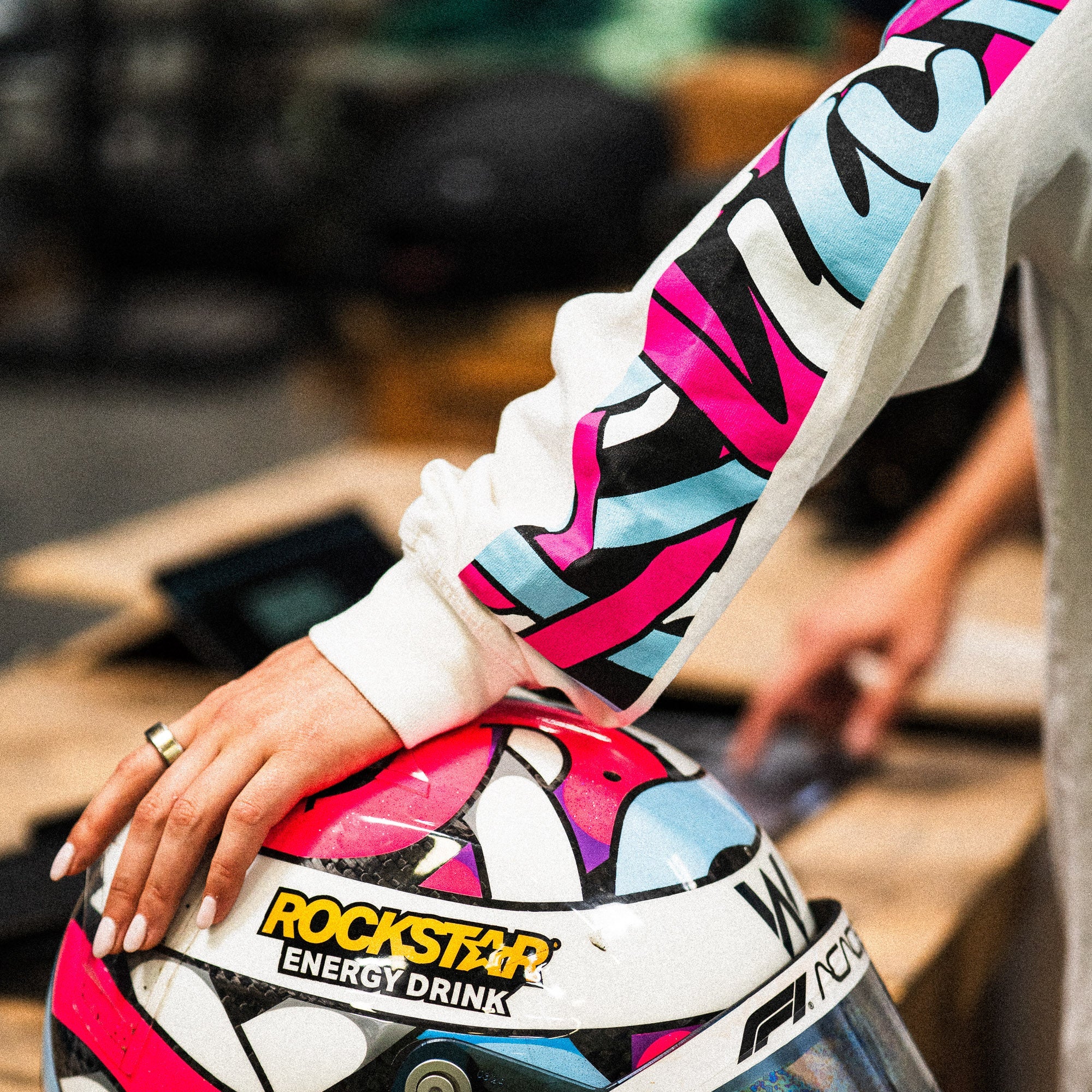 Hoonigan x Lia Block SCRIPT Long Sleeve T-Shirt featuring vibrant graphics and a close-up of a colorful helmet.