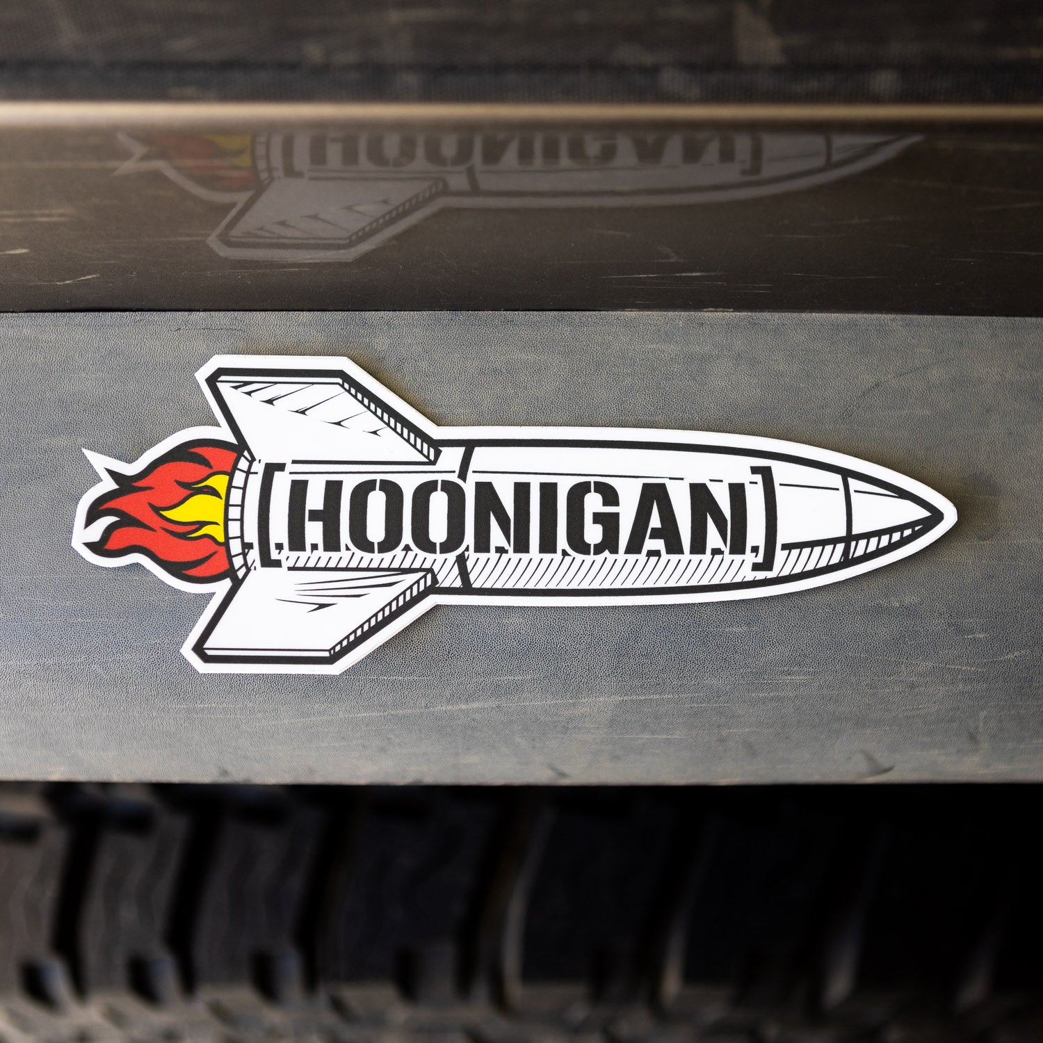 Hoonigan ROCKET sticker featuring a stylized rocket with flames, designed for automotive enthusiasts.