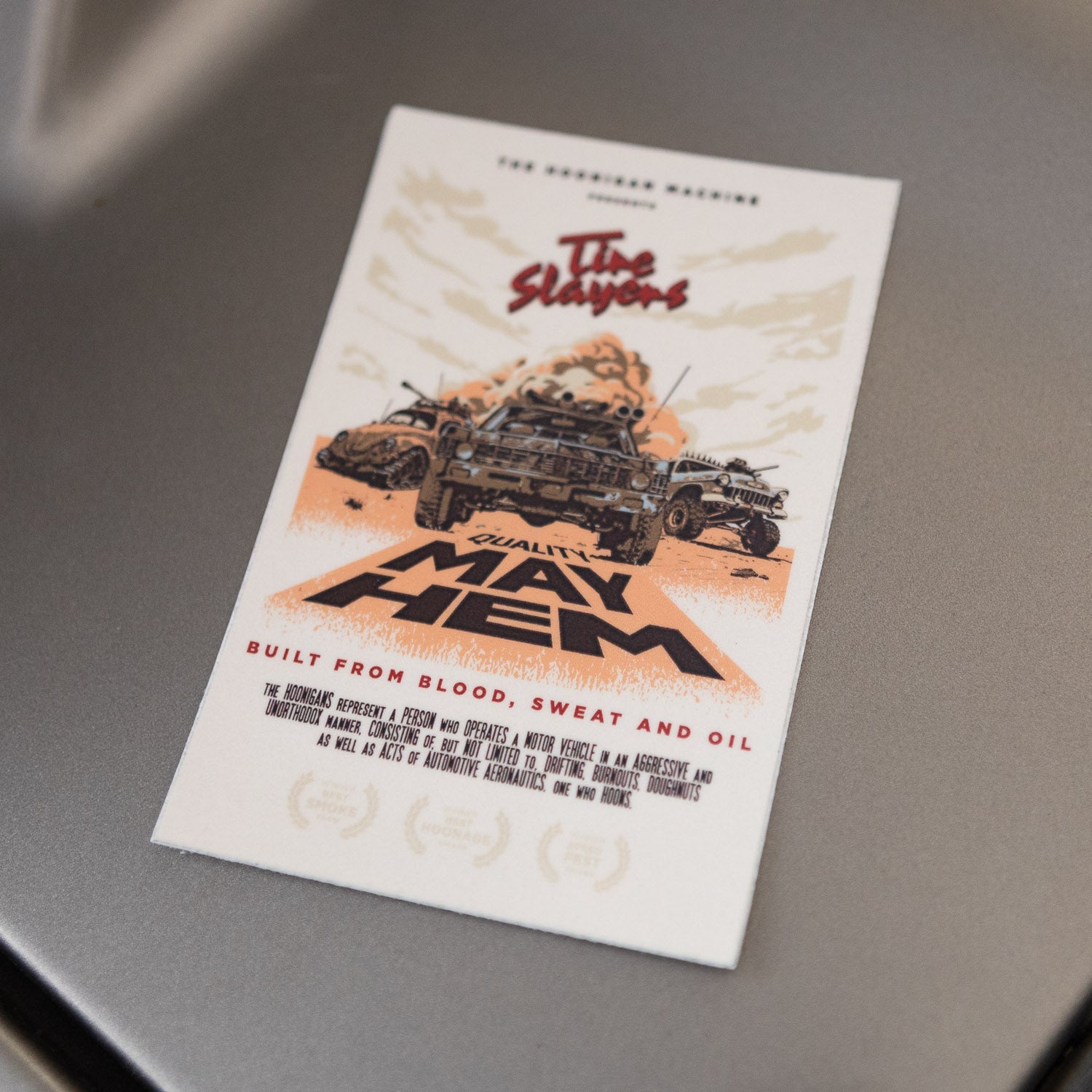 Hoonigan MAYHEM ROAD sticker featuring bold graphics of vehicles and the text "Built from Blood, Sweat and Oil.