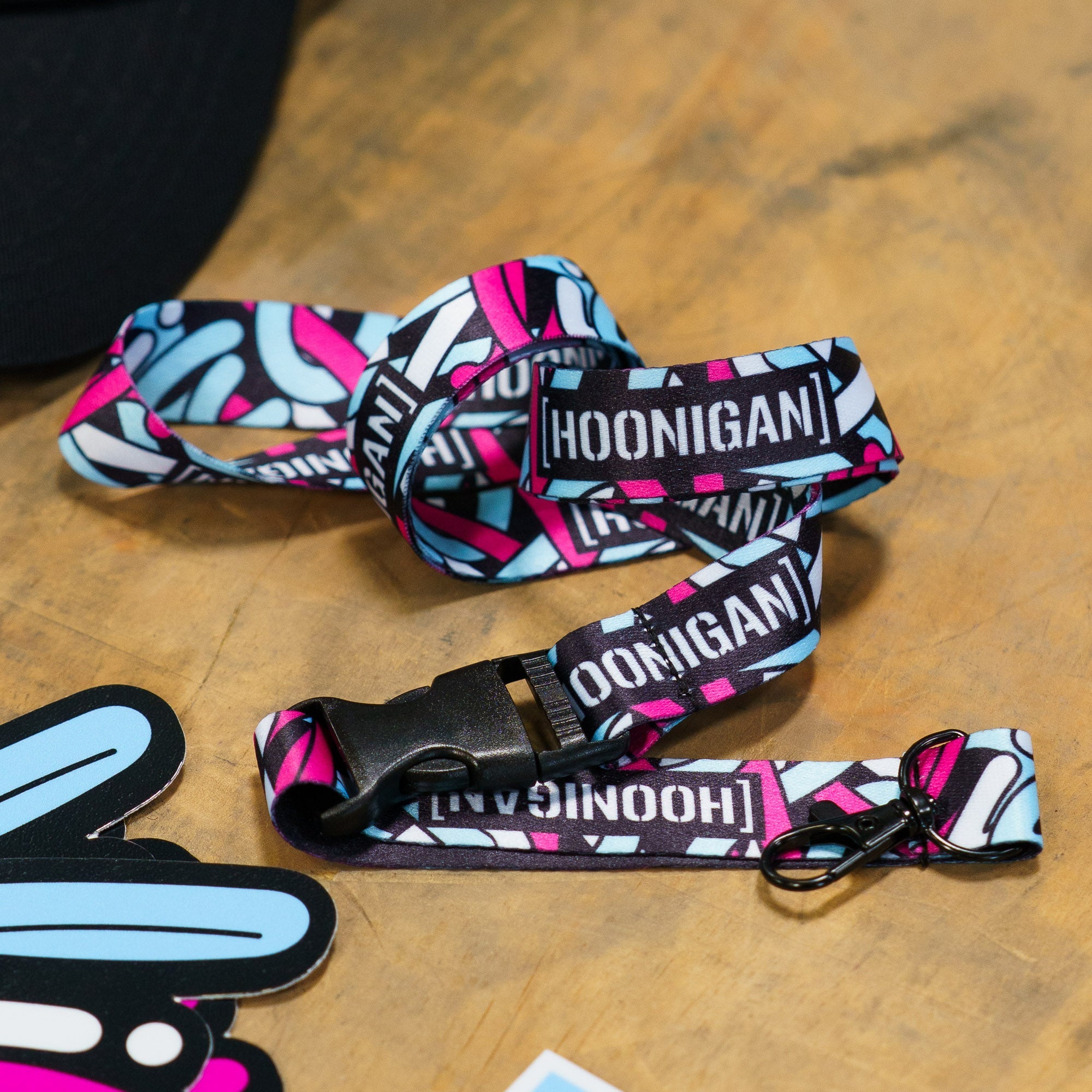 Colorful Hoonigan x Lia Block SCRIPT lanyard featuring bold branding and a stylish design, perfect for motorsport enthusiasts.