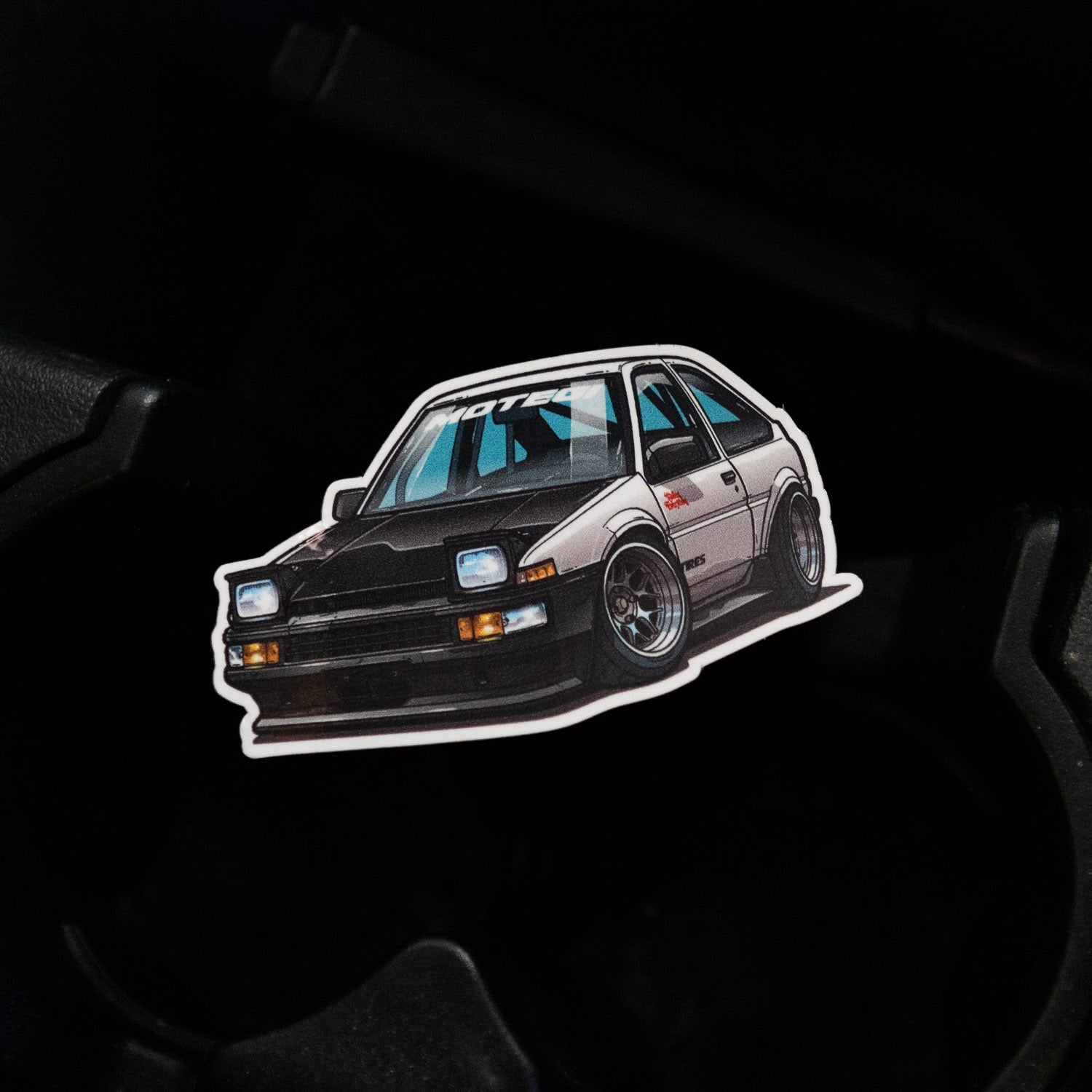 Hoonigan x Motegi SD sticker featuring a detailed illustration of a modified car in a sleek design.