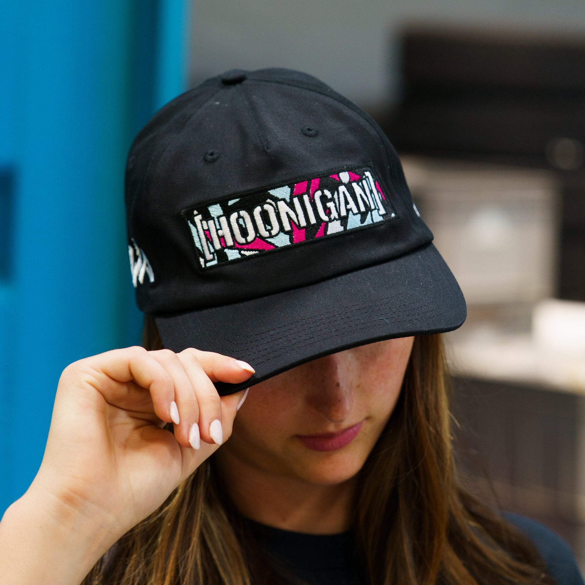 Black unstructured snapback hat featuring a colorful Hoonigan x Lia Block logo on the front, perfect for motorsport fans.