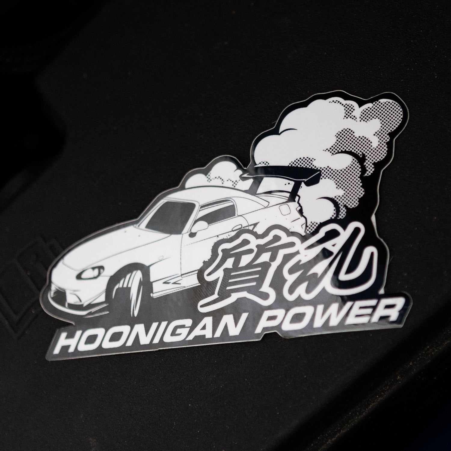 Hoonigan ON SITE sticker featuring a car with smoke and the text "Hoonigan Power" in bold lettering.