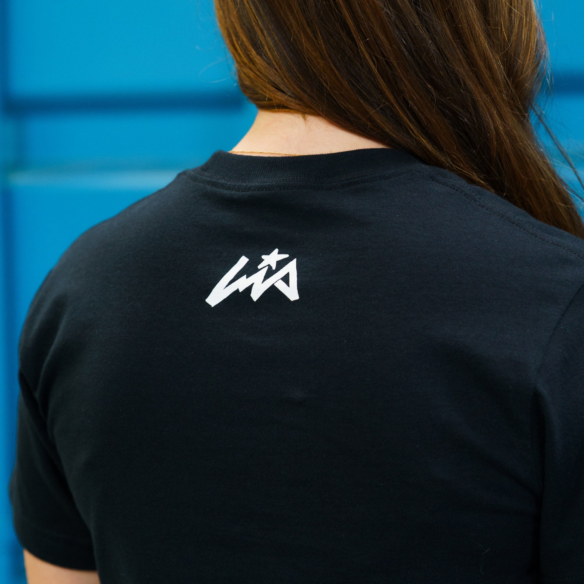 Black short sleeve t-shirt featuring a white Lia Block logo on the back, perfect for motorsport enthusiasts.