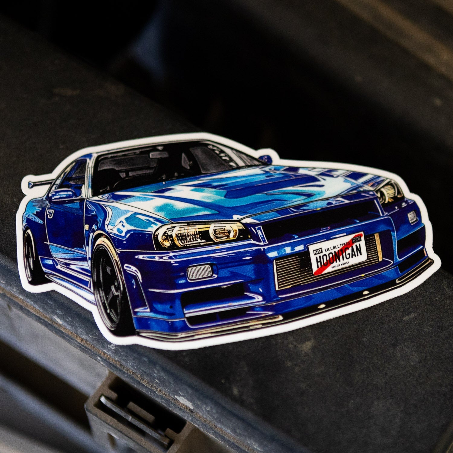 Hoonigan KING OF MONSTERS sticker featuring a detailed blue sports car design, perfect for automotive enthusiasts.