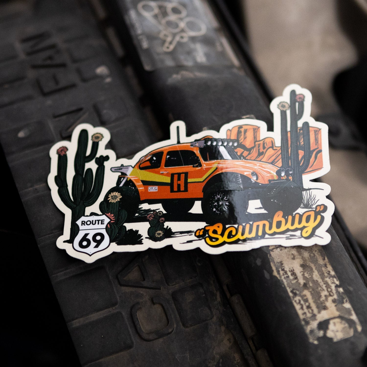 Hoonigan SCUMBUG sticker featuring a vibrant off-road vehicle design with cacti and Route 69 signage.