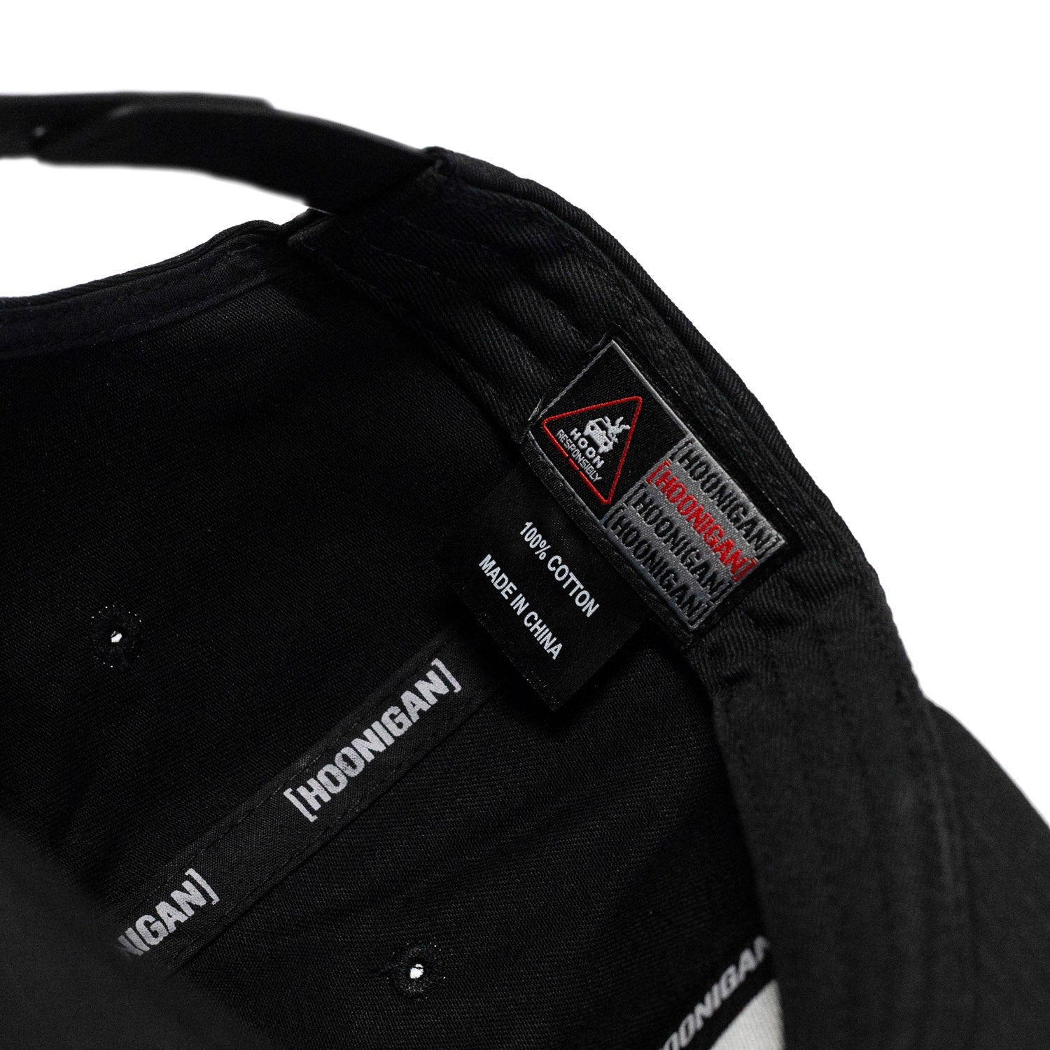 Black Hoonigan PATRIOT Snapback Hat featuring a cotton fabric and branded interior tags for motorsport enthusiasts.