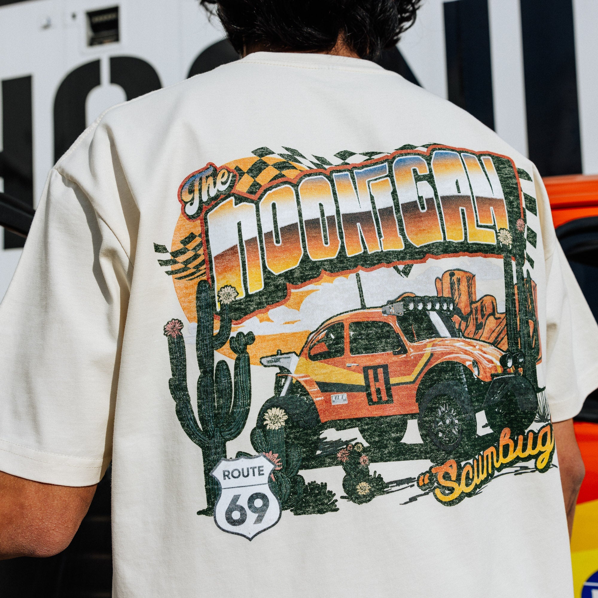 Hoonigan SCUMBUG short sleeve t-shirt featuring a vibrant graphic of a modified truck with desert elements.