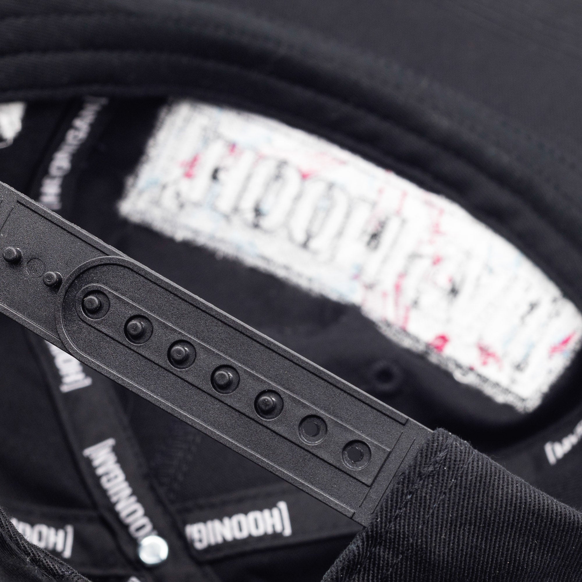 Unstructured black snapback hat featuring Hoonigan branding and adjustable strap for a comfortable fit.
