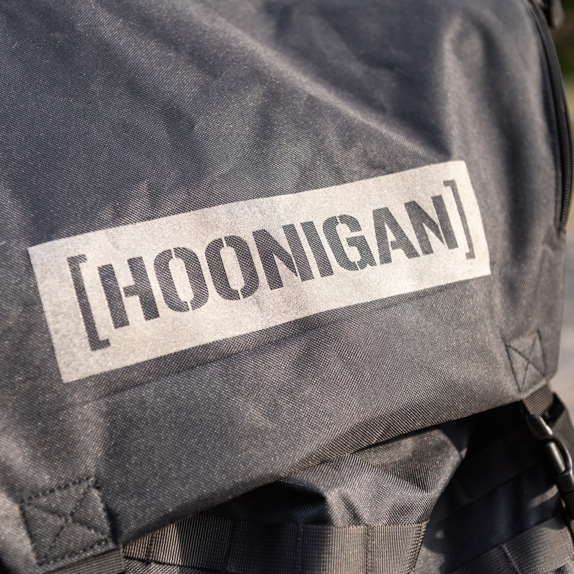 Hoonigan CENSOR BAR backpack featuring a bold logo, designed for automotive enthusiasts and outdoor adventures.